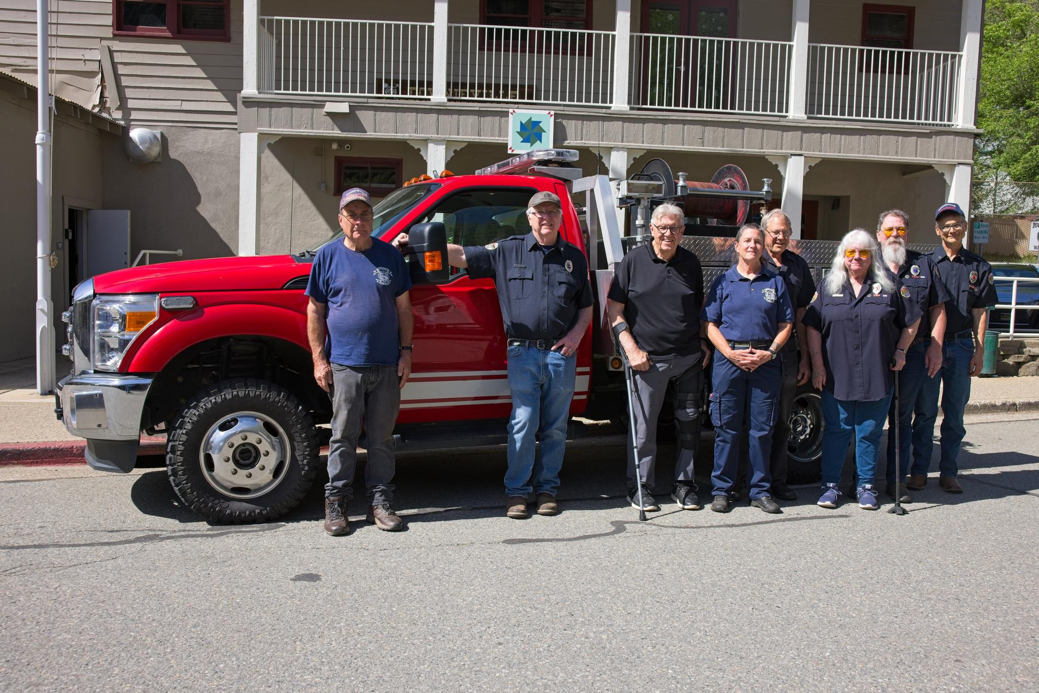 Members of the Downieville Volunteer Fire Department in front of the newly-acquired engine.