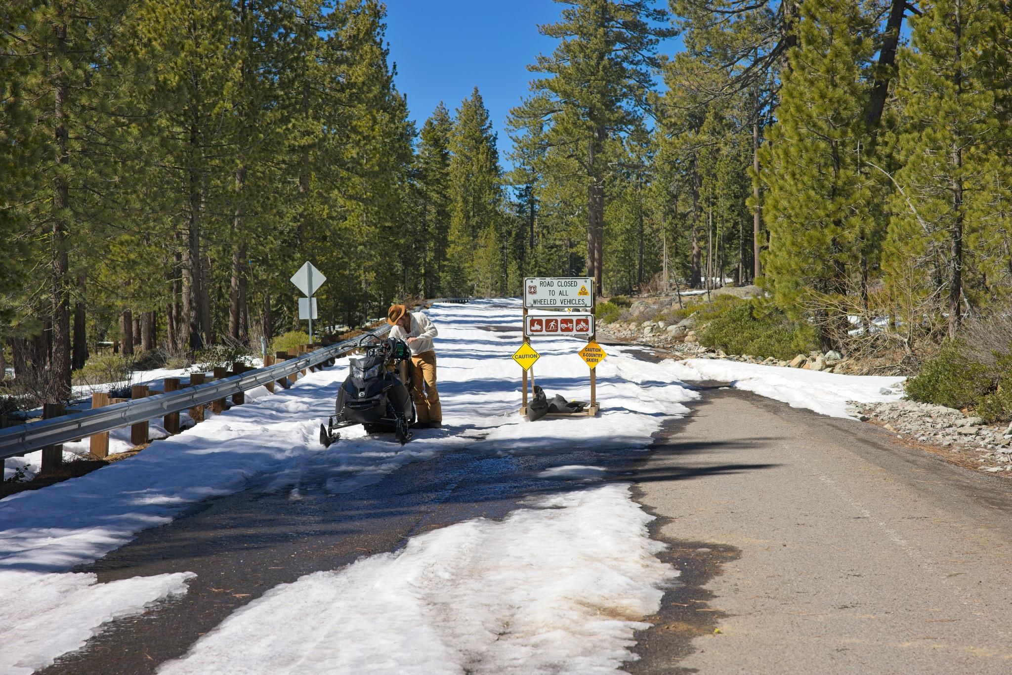 A snowmobiler on Gold Lake Highway, closed to wheeled vehicles but maintained for recreational use, on Thursday, March 12.