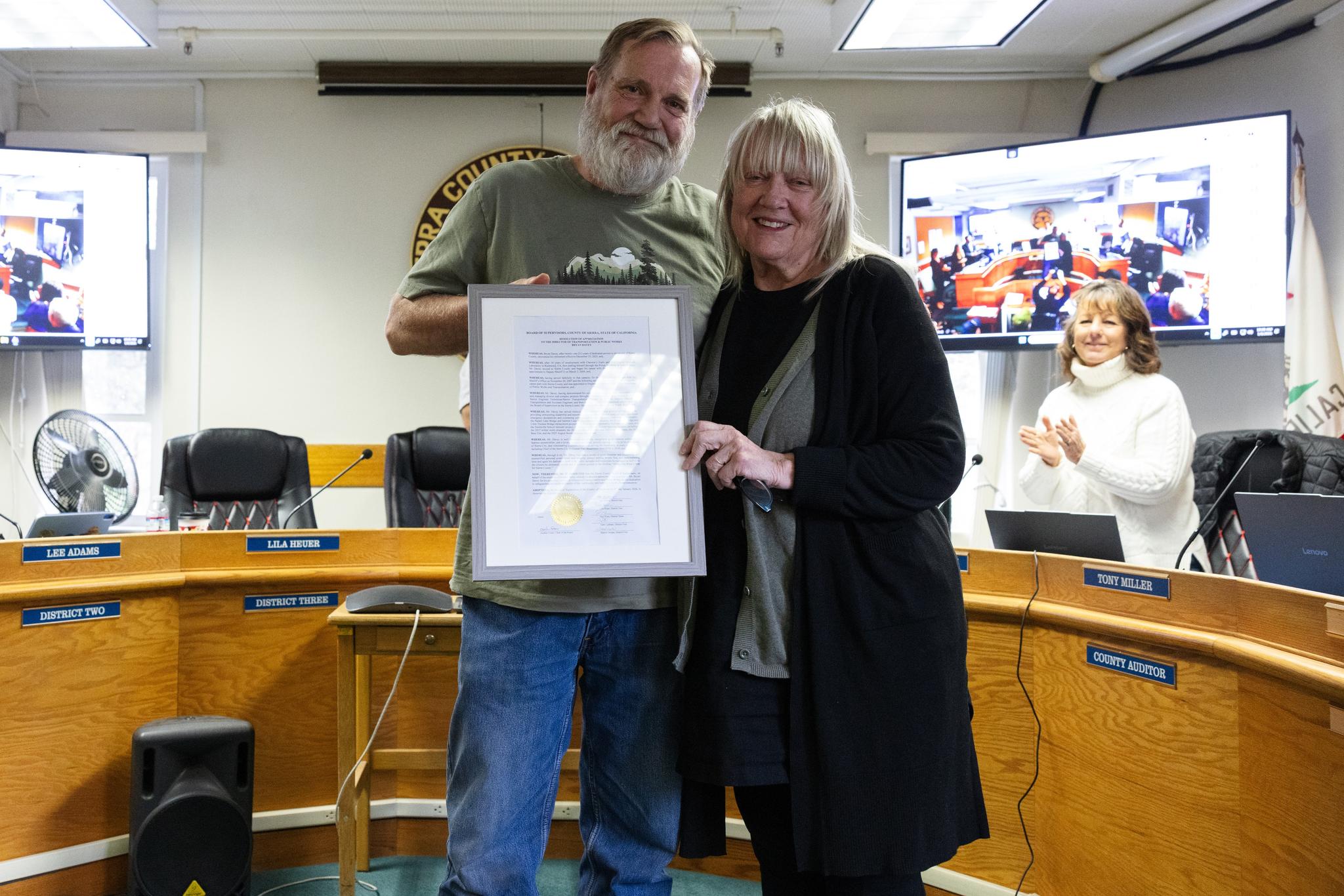 Supervisor Lila Heuer presents former Public Works Director Bryan Davey with a resolution of appreciation.