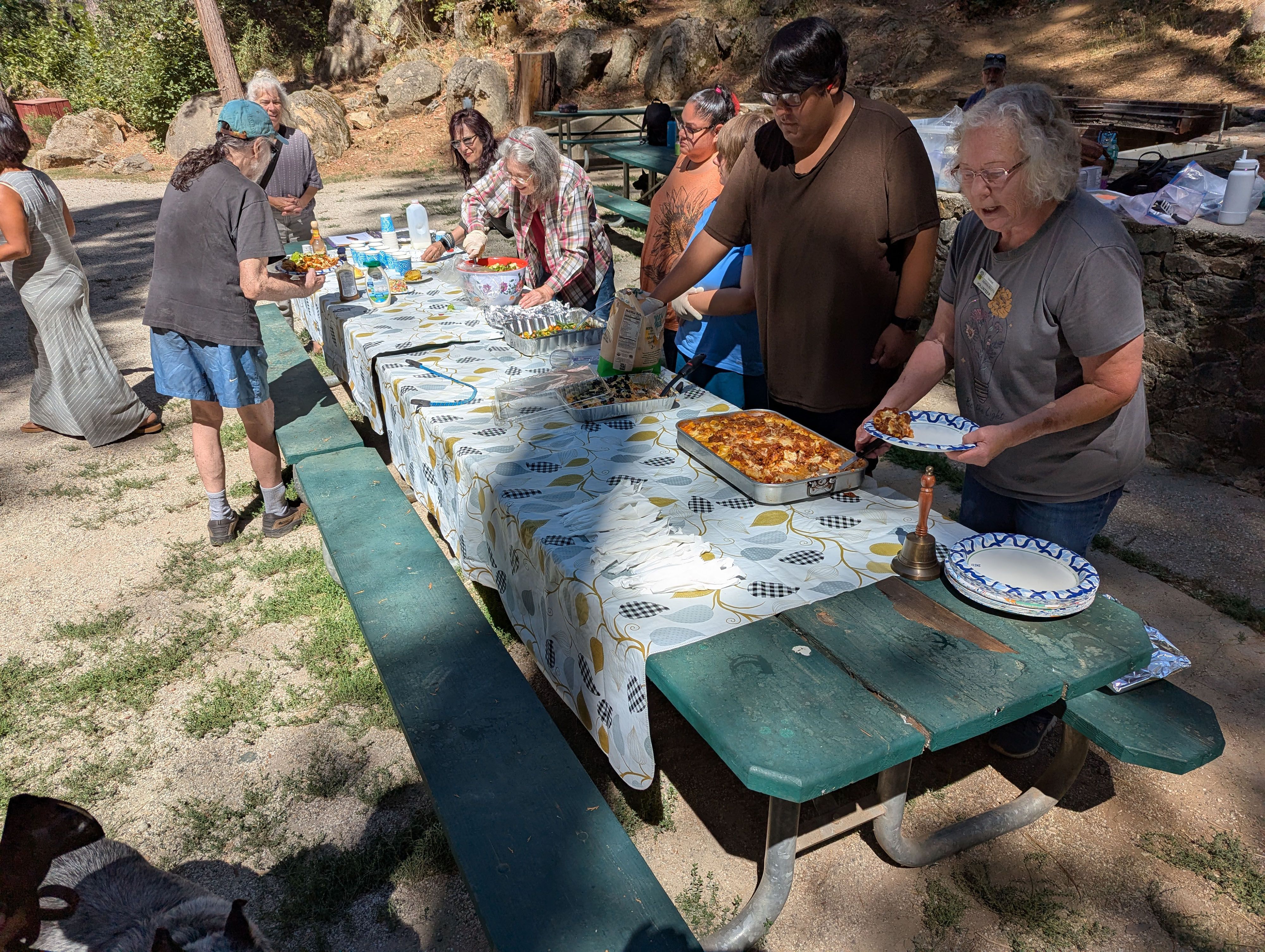 Homemade lasagne and the fixings are served by volunteers at the Sierra Roots weekly lunch in Pioneer Park.