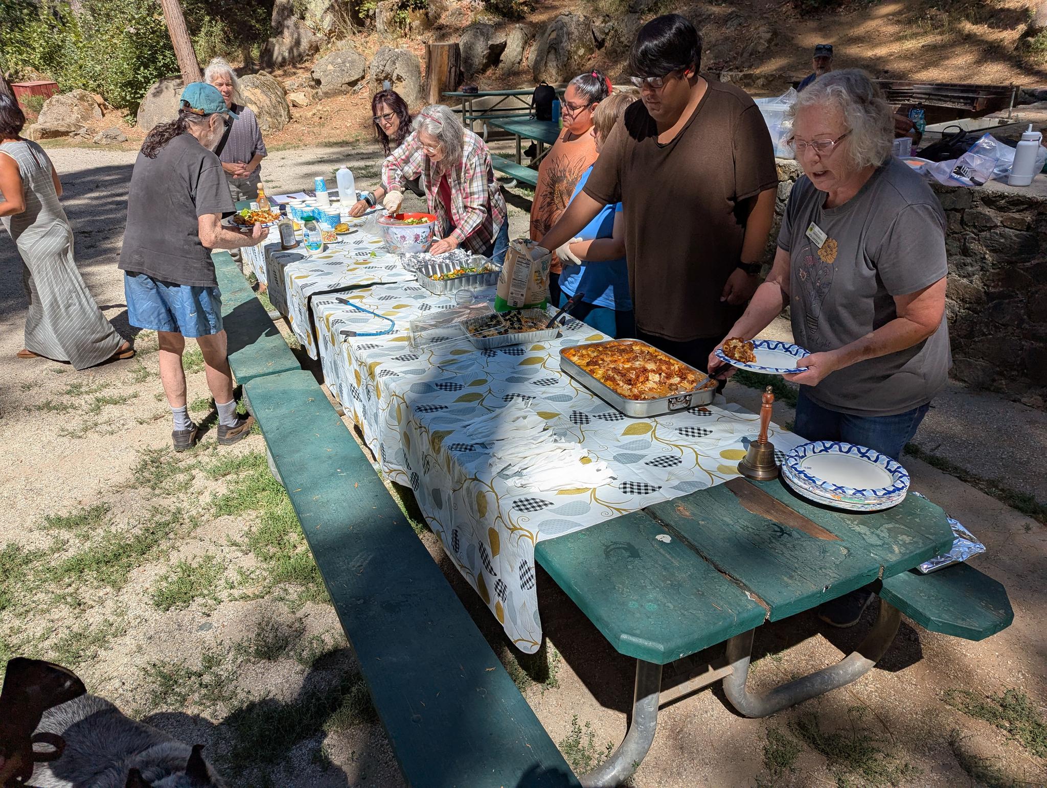 Homemade lasagne and the fixings are served by volunteers at the Sierra Roots weekly lunch in Pioneer Park.