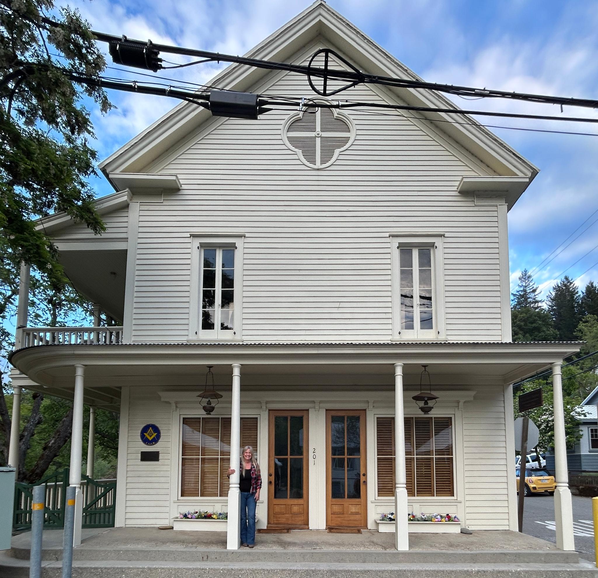 Local resident Mrs. Kristy Folsom on the porch of the previous Masonic Mountain Shade Lodge #18, now an office building.