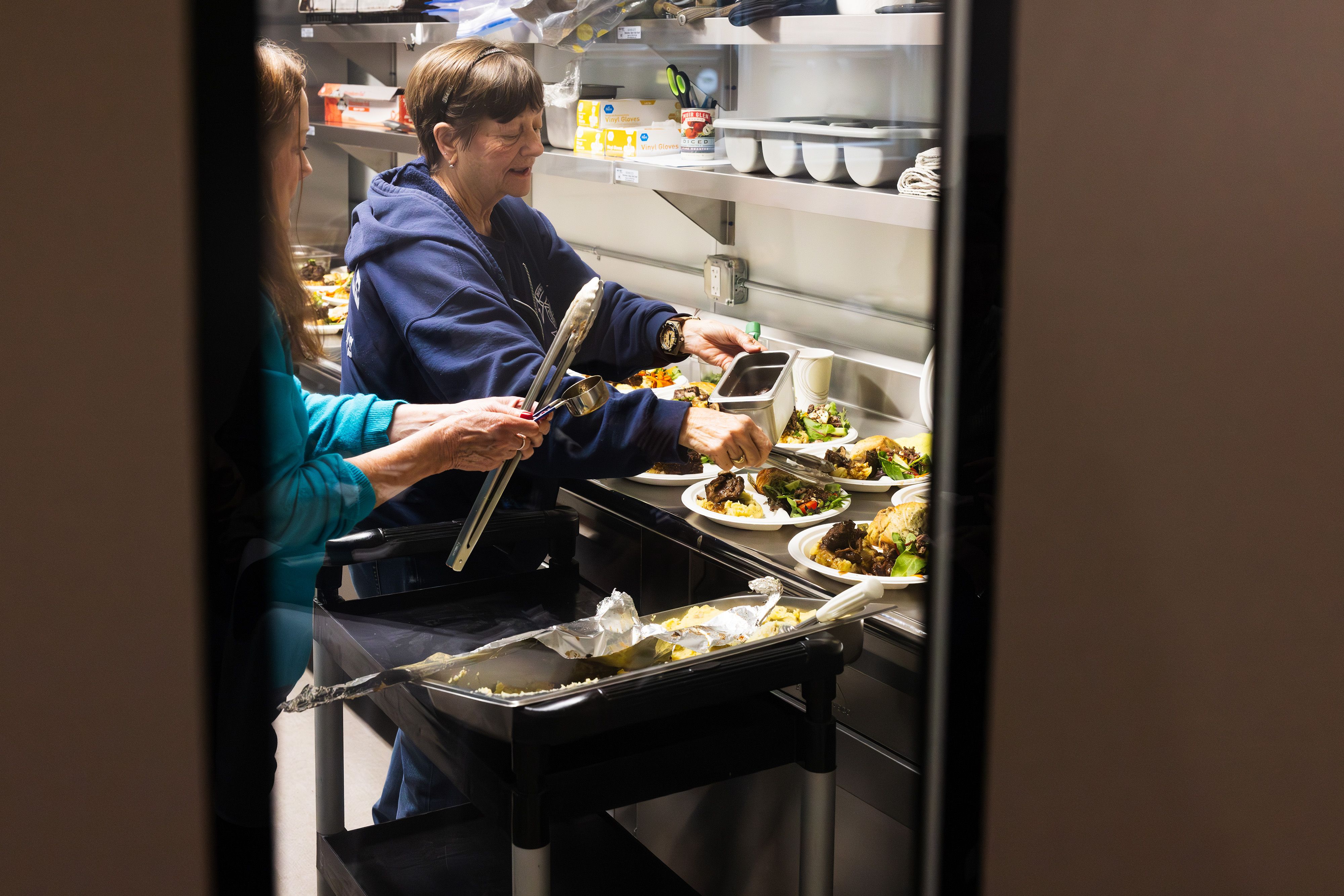 Jacie Epperson helps prepare meals