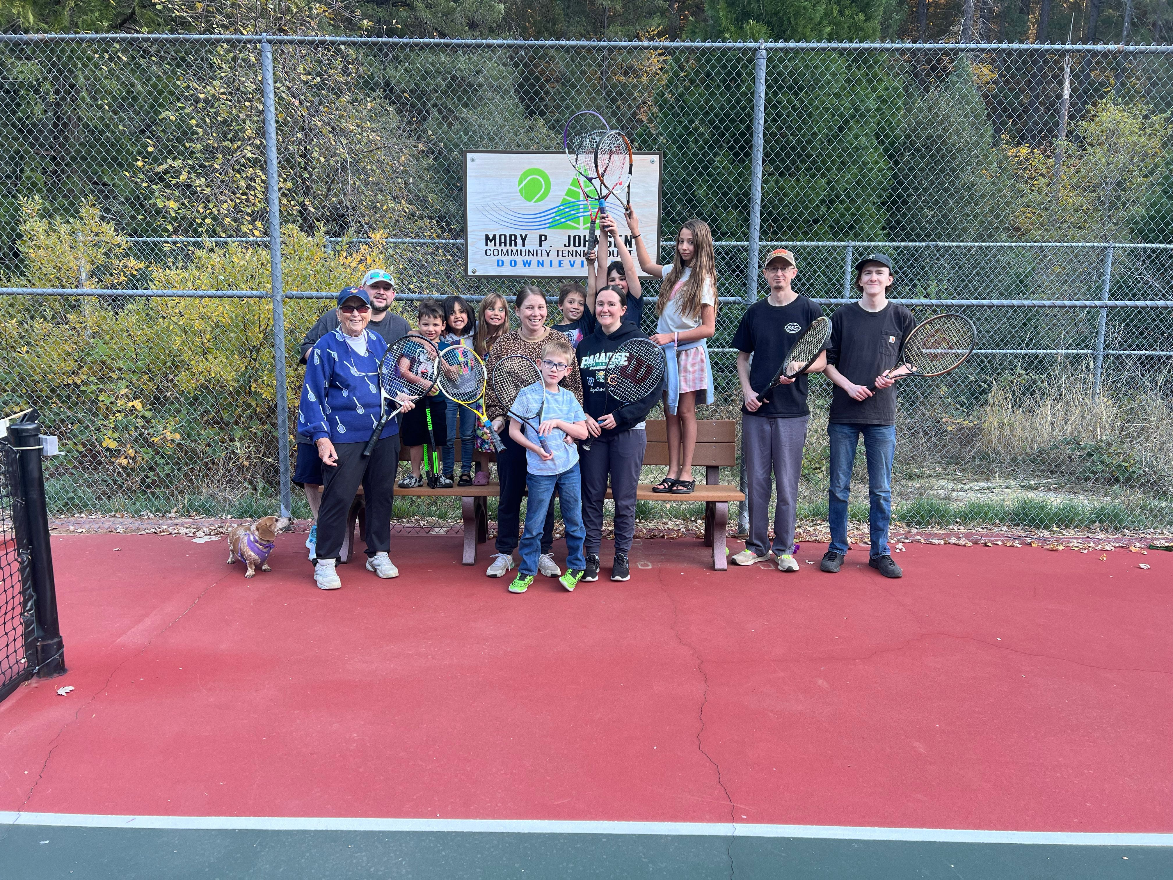 Tennis Clinic participants gather at the Mary P. Johnsen (left) Community Tennis Court in Downieville
