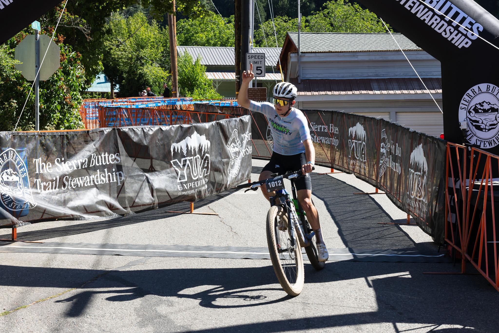 Dan English crosses the finish line on Saturday, winning the cross-country race.