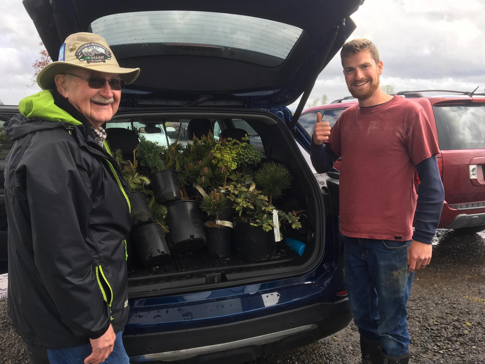 Bob Park (left) and friend load roughly 50 young conifers for travel from Oregon to Grass Valley as Conifer Hill was being created. Photo by Patty Park.