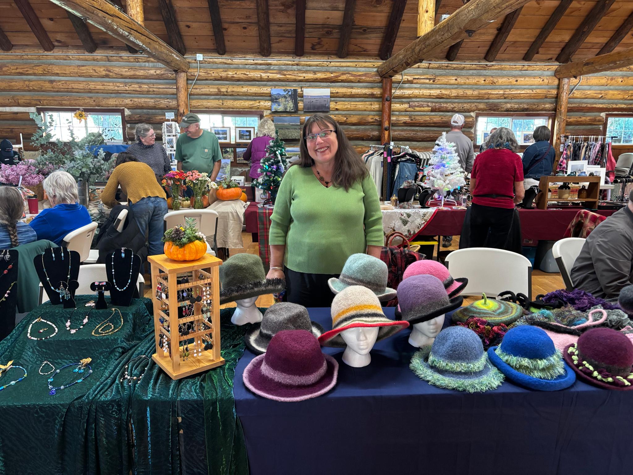 Sylvia Baiker with an array of her felted hats.