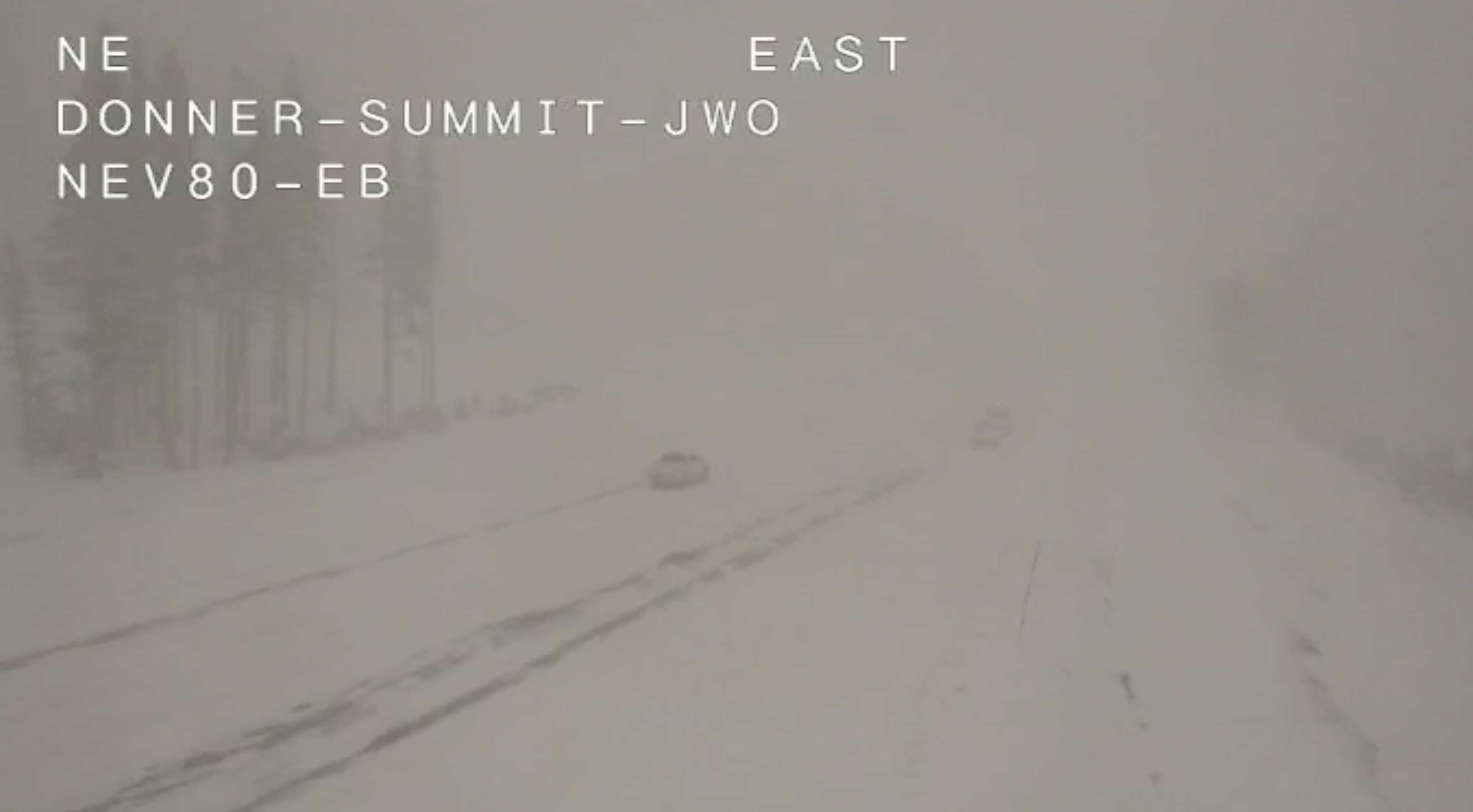 Traffic cameras on Interstate 80 show icy roads, high winds, and low visibility.