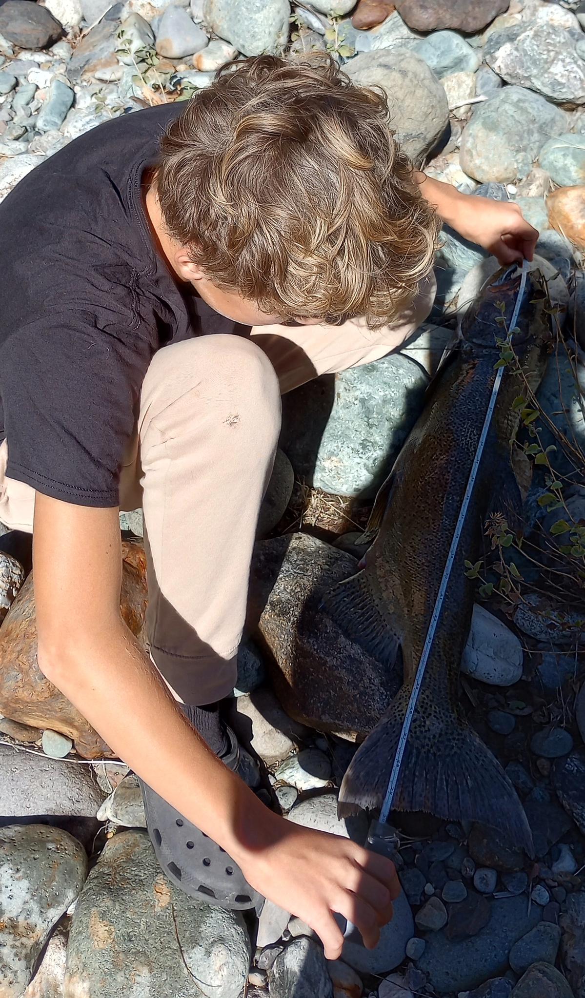 Drew measures his catch at Rocky Rest.