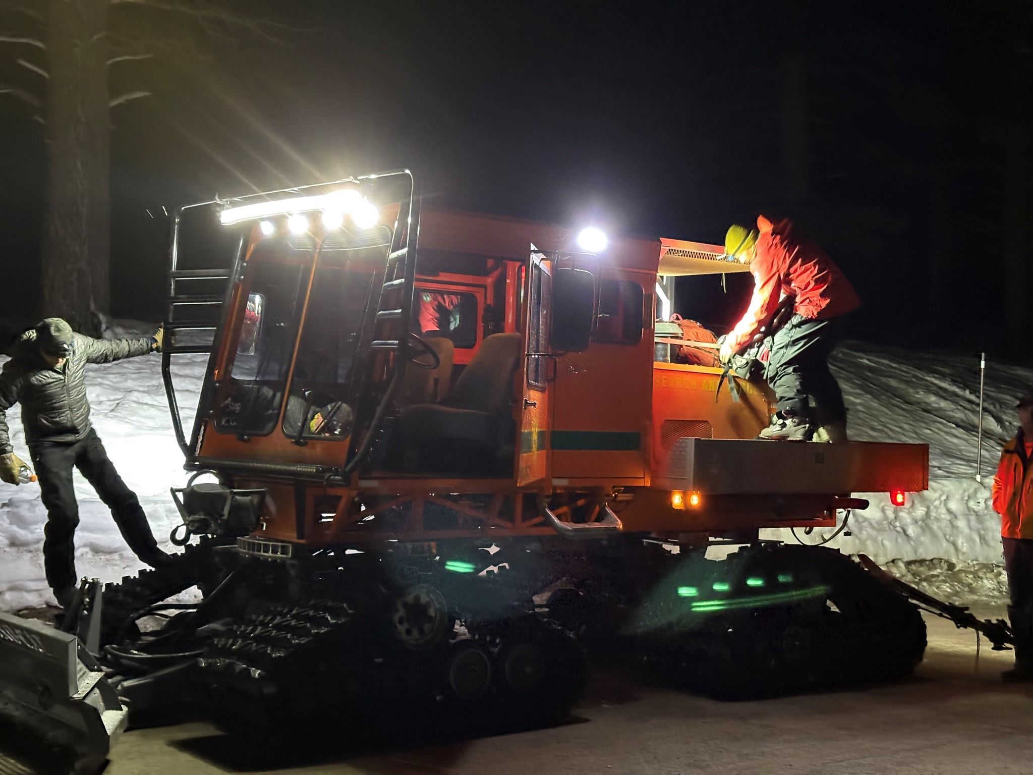 A snowcat assisted in transporting the stranded snowmobiler to safety.