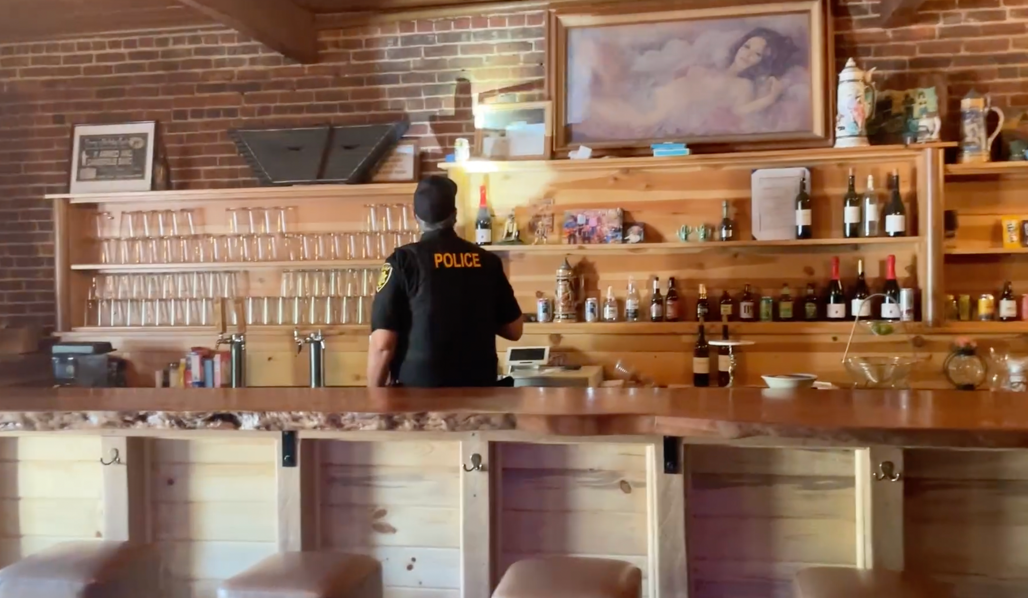Police behind the bar at the Brass Rail Tavern. Image taken from a Nevada County Sheriff’s Office video.