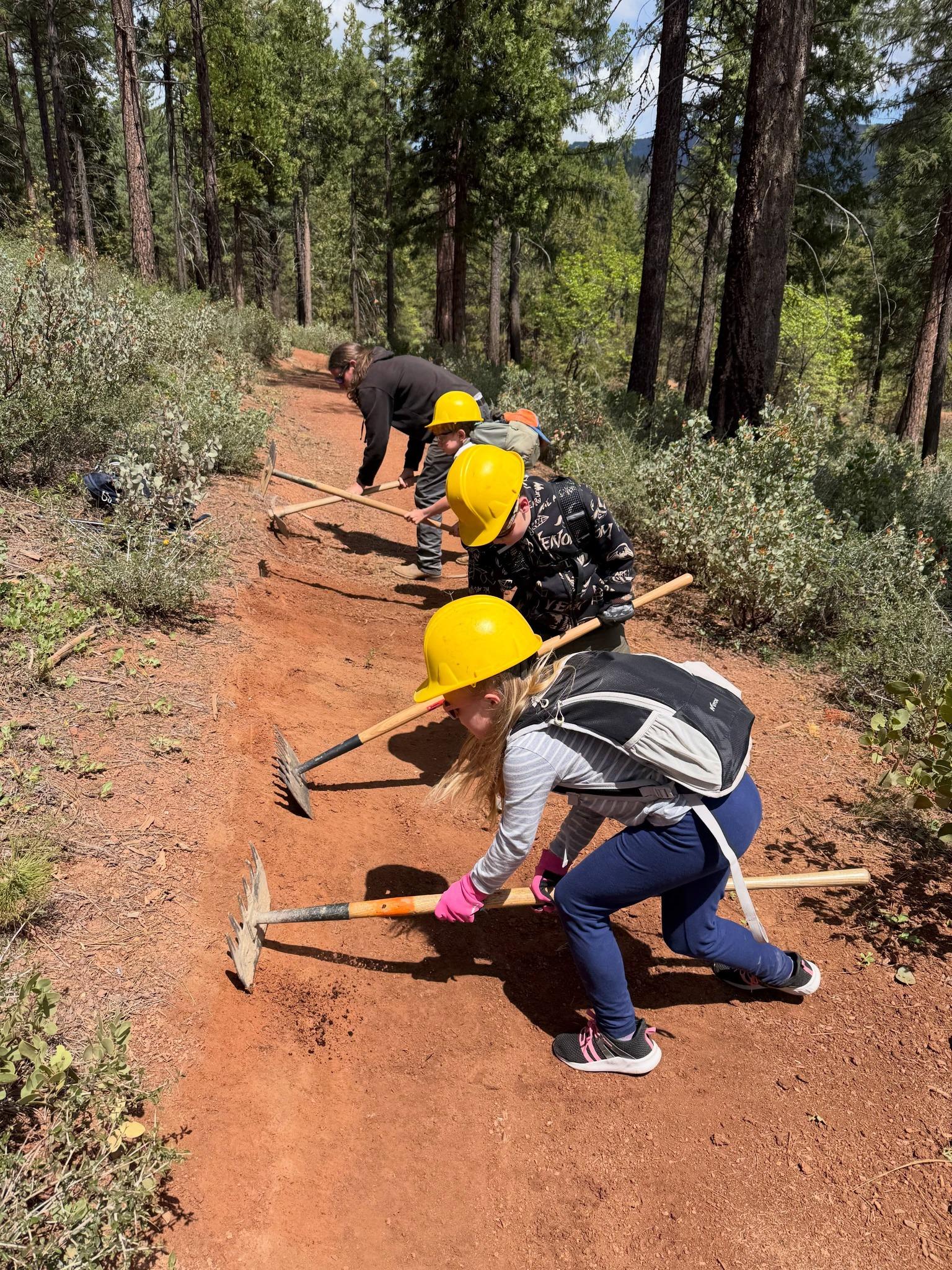 Children practice trail maintenance during a field session. Credit: SBTS / Facebook.