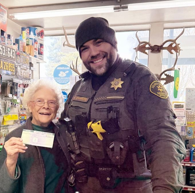 Lieutenant Kameron Crawford delivered a first restitution check to Bonnie White on March 30th. Photo courtesy of Sierra County Sheriff’s Office.