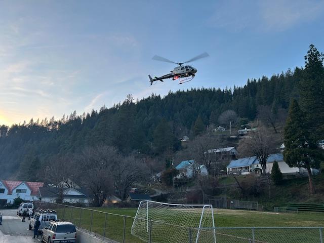 A CHP helicopter takes off from the Downieville School field after being configured for a hoist rescue operation. Photo by Don Potter.