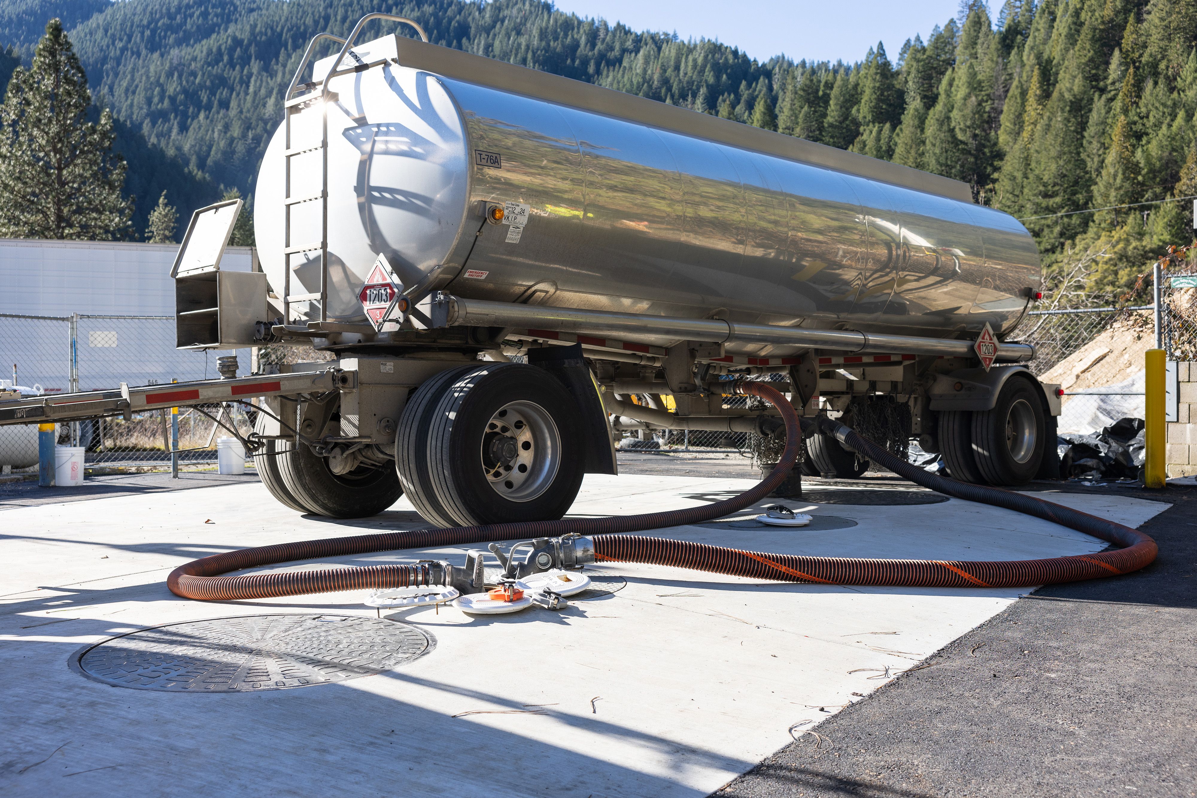 Gas station tanks hooked up to the gas truck