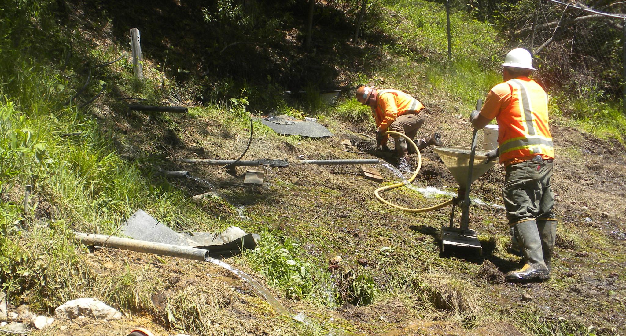 May 16, 2017 — Neil’s Control Blasting workers pumping cement to seal a hole