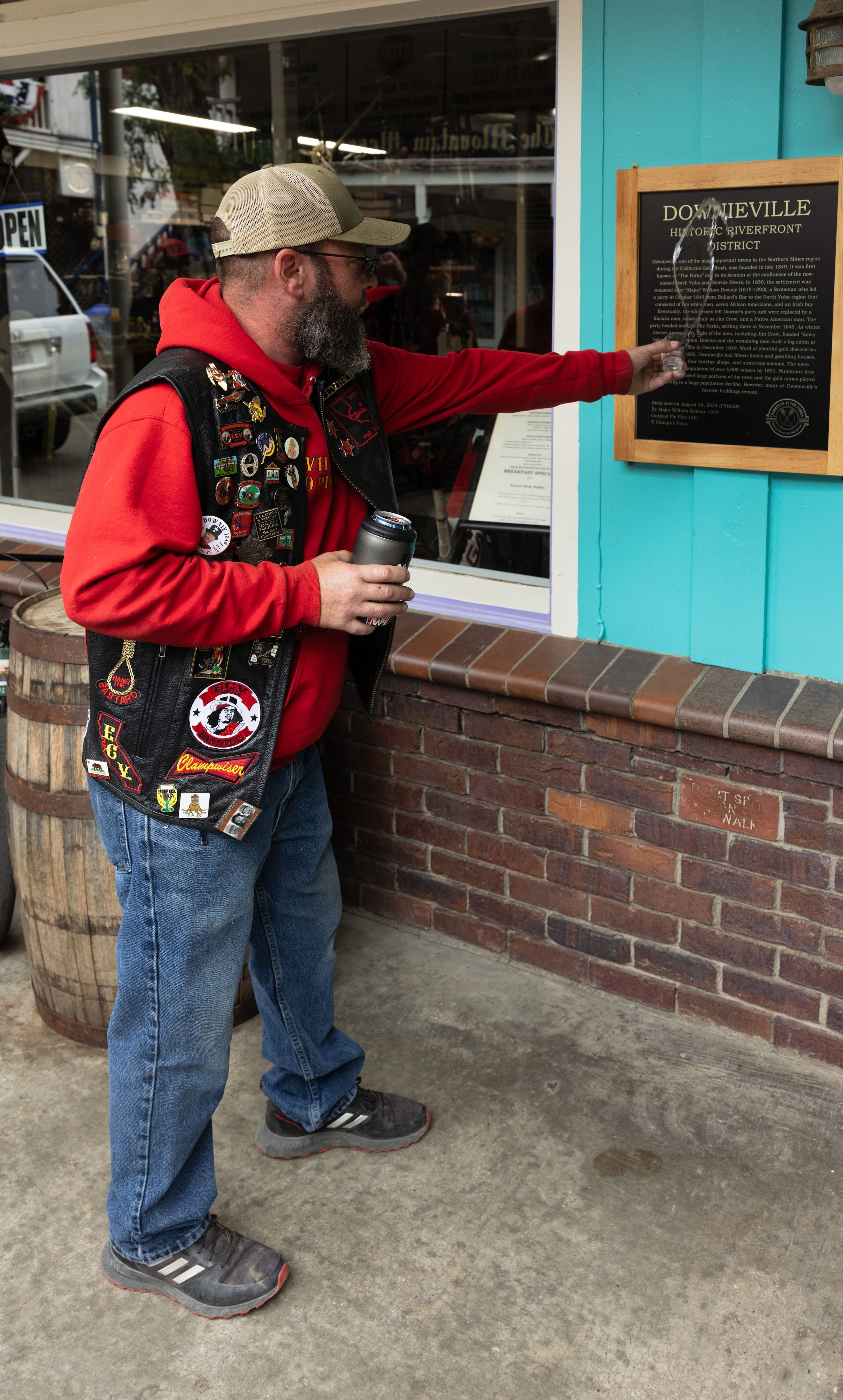 Christopher Hale christens the plaque outside Sabrina’s at the Forks with a shot of vodka