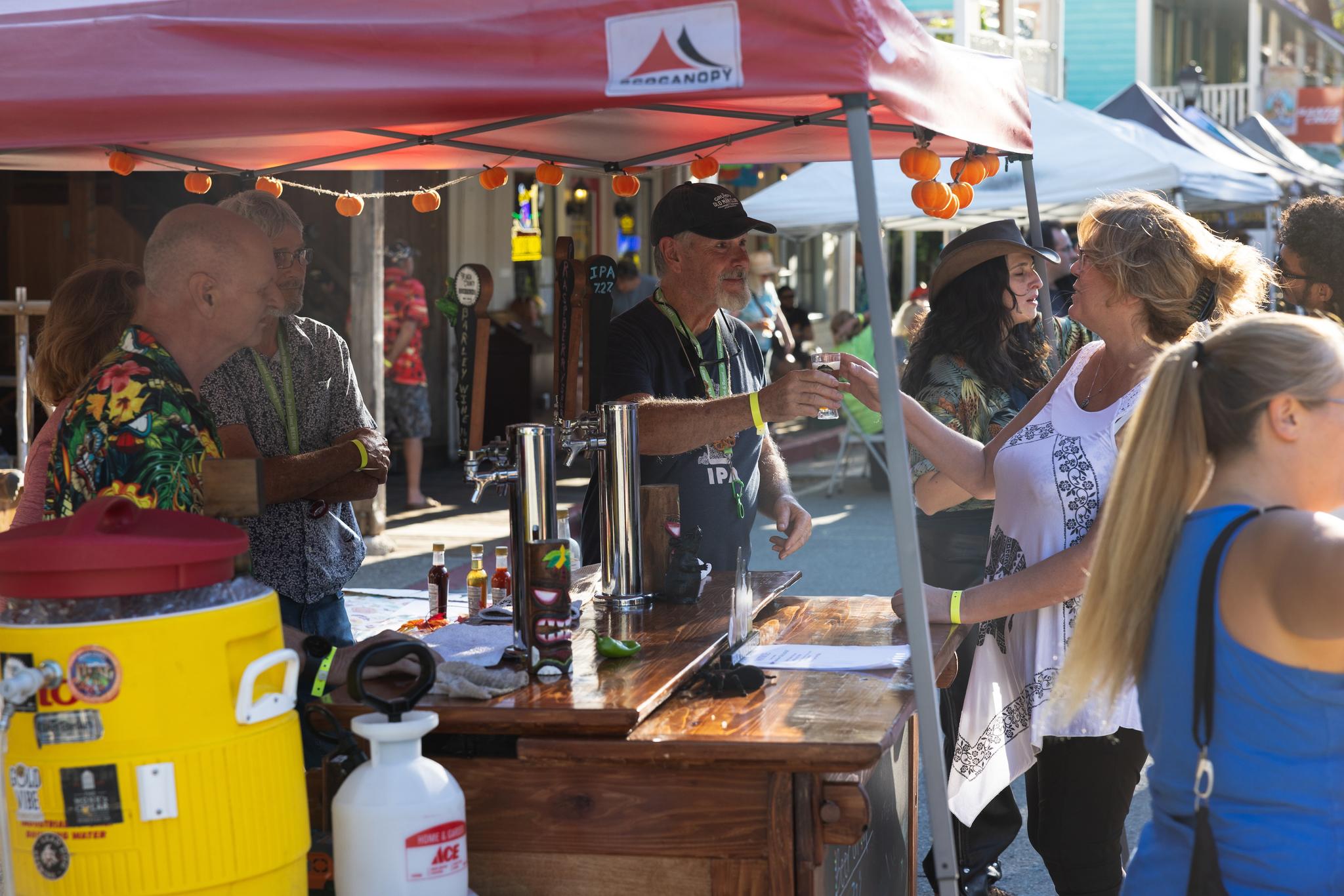Representative of the Nevada County Brewers hands out a sample