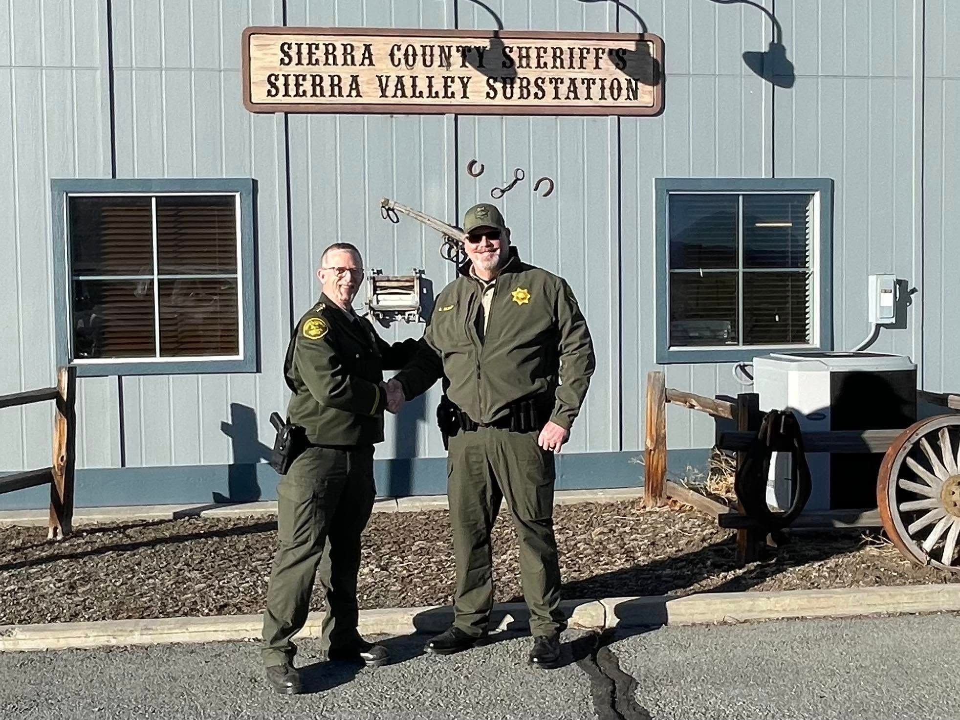 Fisher congratulates Deputy Sexton after his swearing-in.