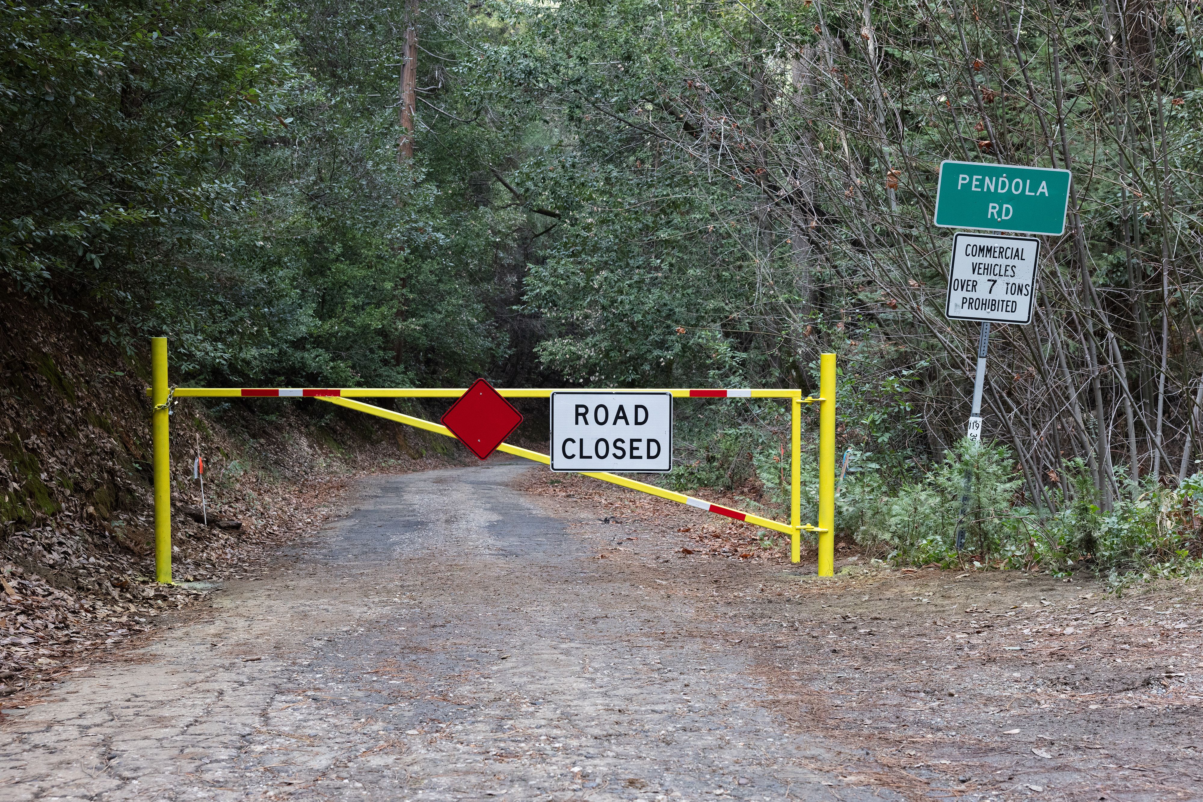 A gate blocks entrance to Pendola Road next to Highway 49
