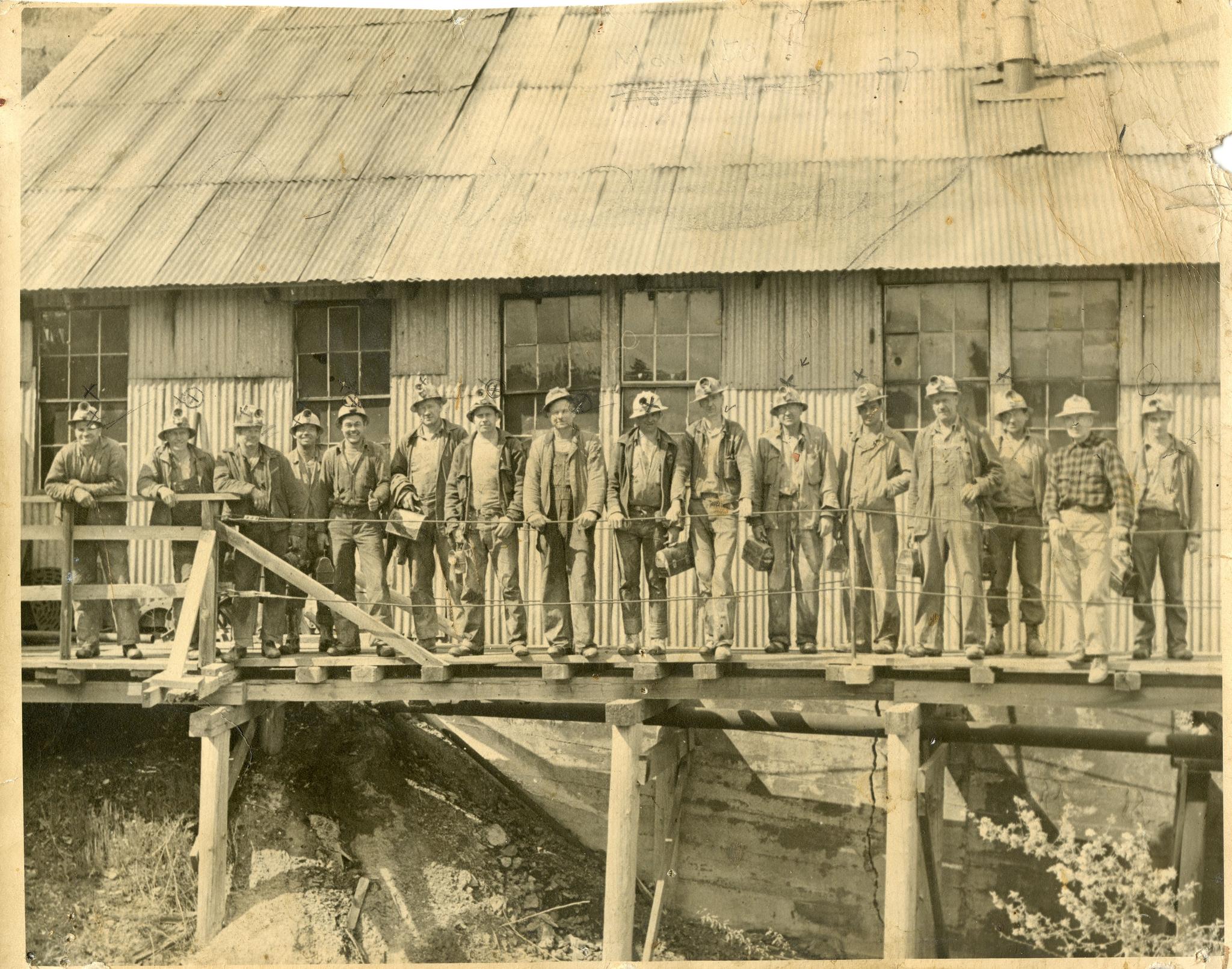 Sixteen to One Mine Crew, 1950. Milt Sanders is 4th from the right, wearing the overalls. Photo courtesy of undergroundgold.org.