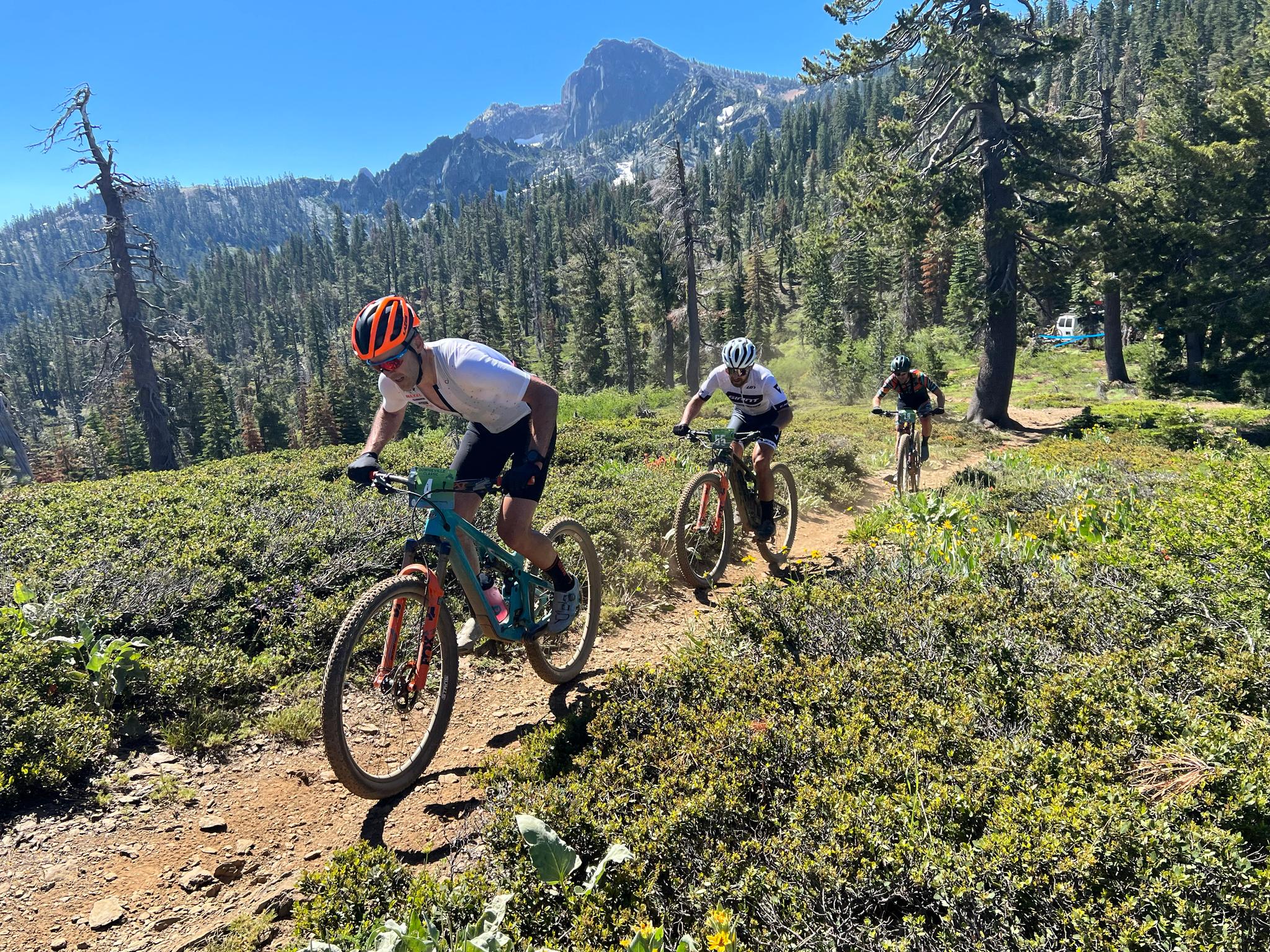 Riders in the 2023 Downieville Classic reach Packers Saddle, the top of the Saturday’s climb from Sierra City