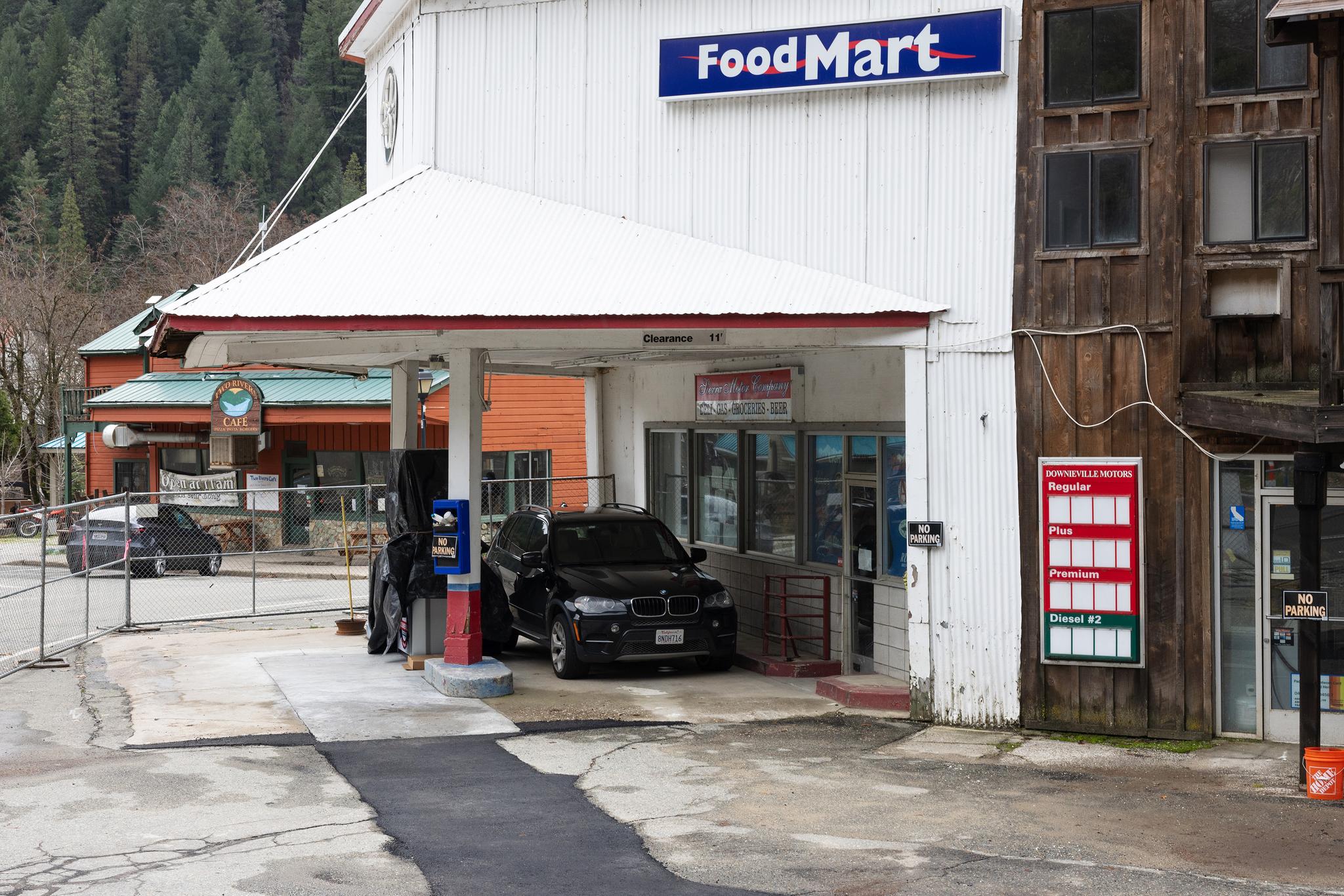 A car parked at the Downieville Motors front gas pump