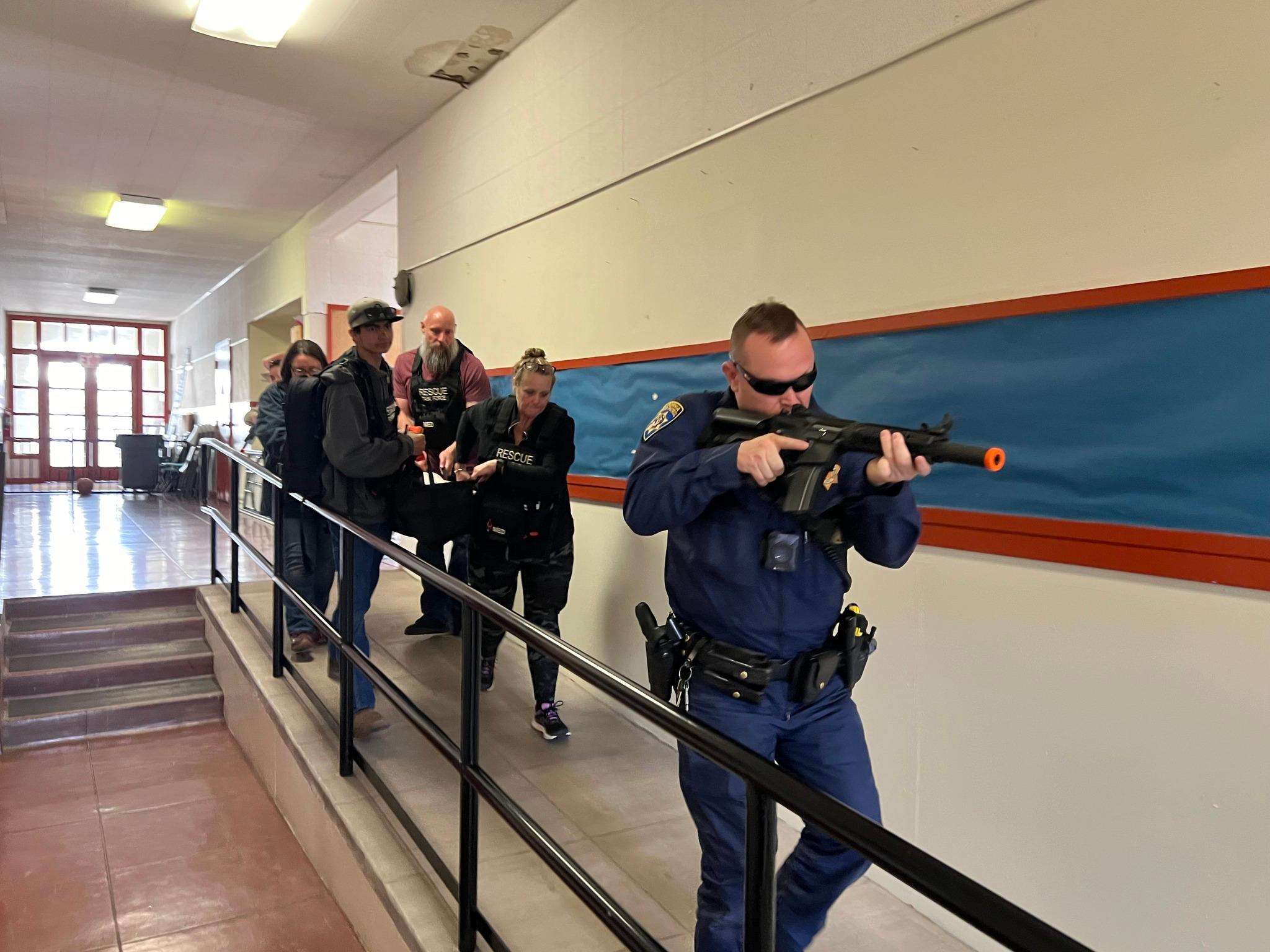 A hallway is cleared for a simulated patient