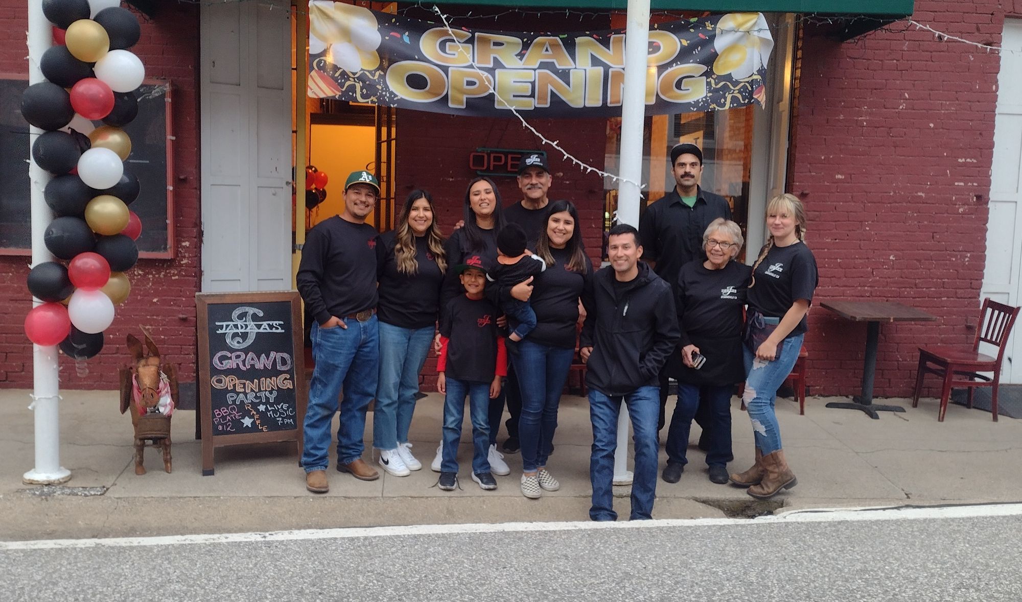John Perez (middle back) celebrates JADAA’s Grand Opening with his team and family
