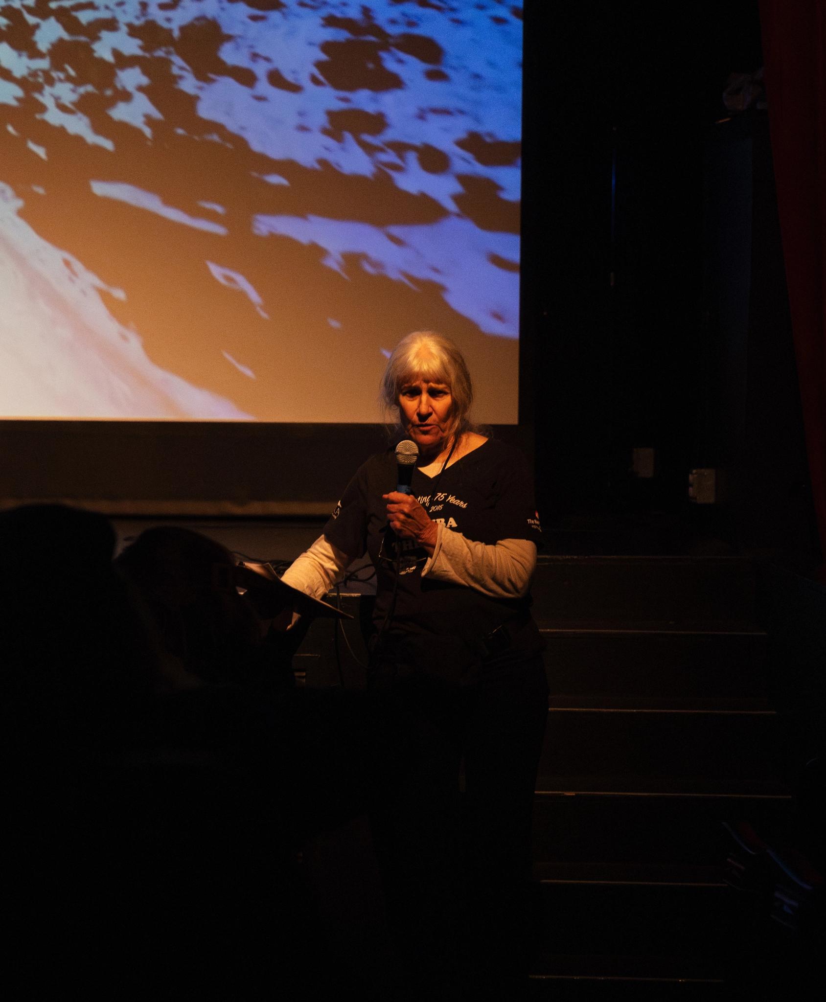 Caroline “Cracker” Eshleman, President of the Sierra County Arts Council, speaks before Friday’s screening.