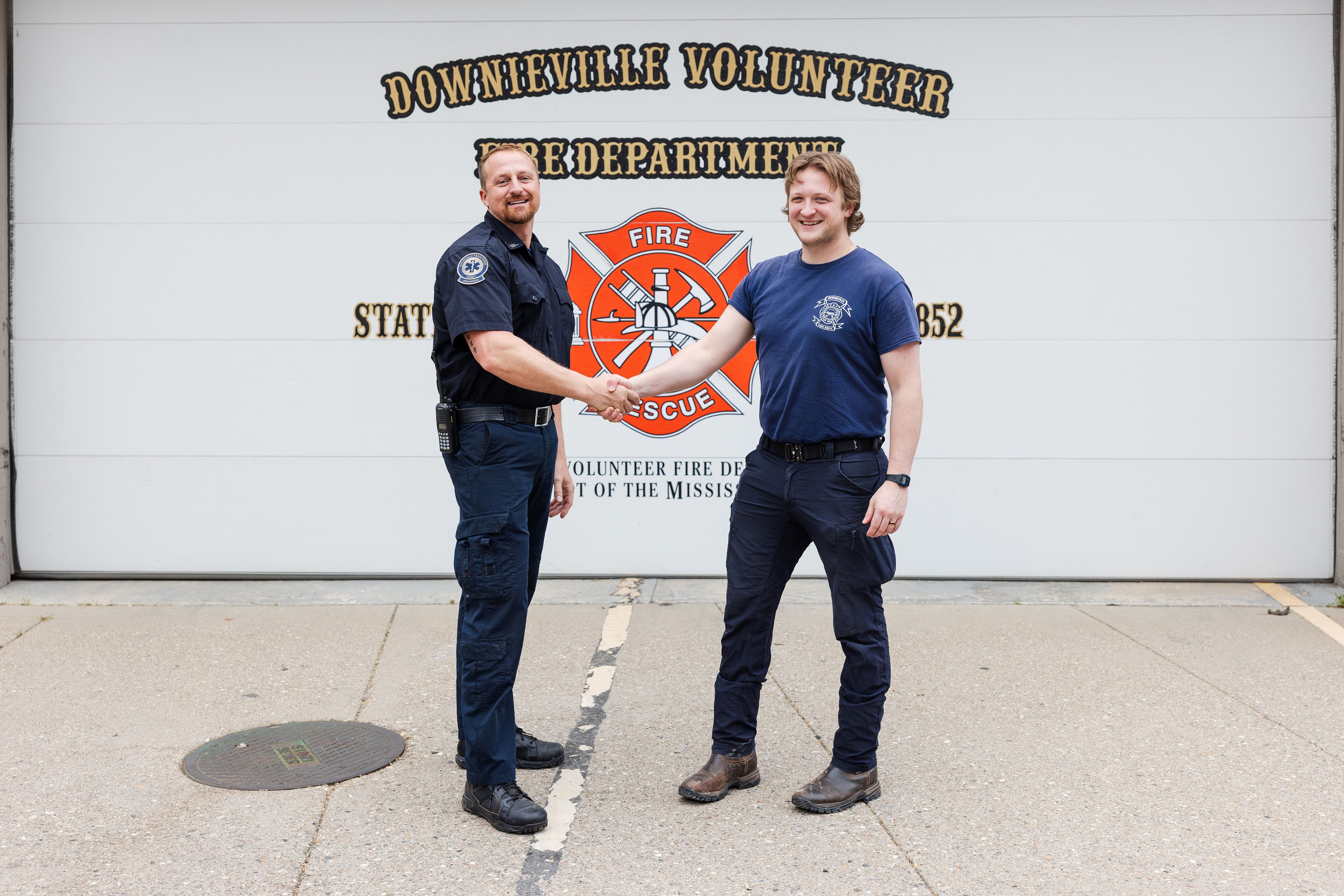 Incoming paramedic Cory Schiemann (left) and outgoing Tegan Harrington (right) in front of the Downieville Fire Station.