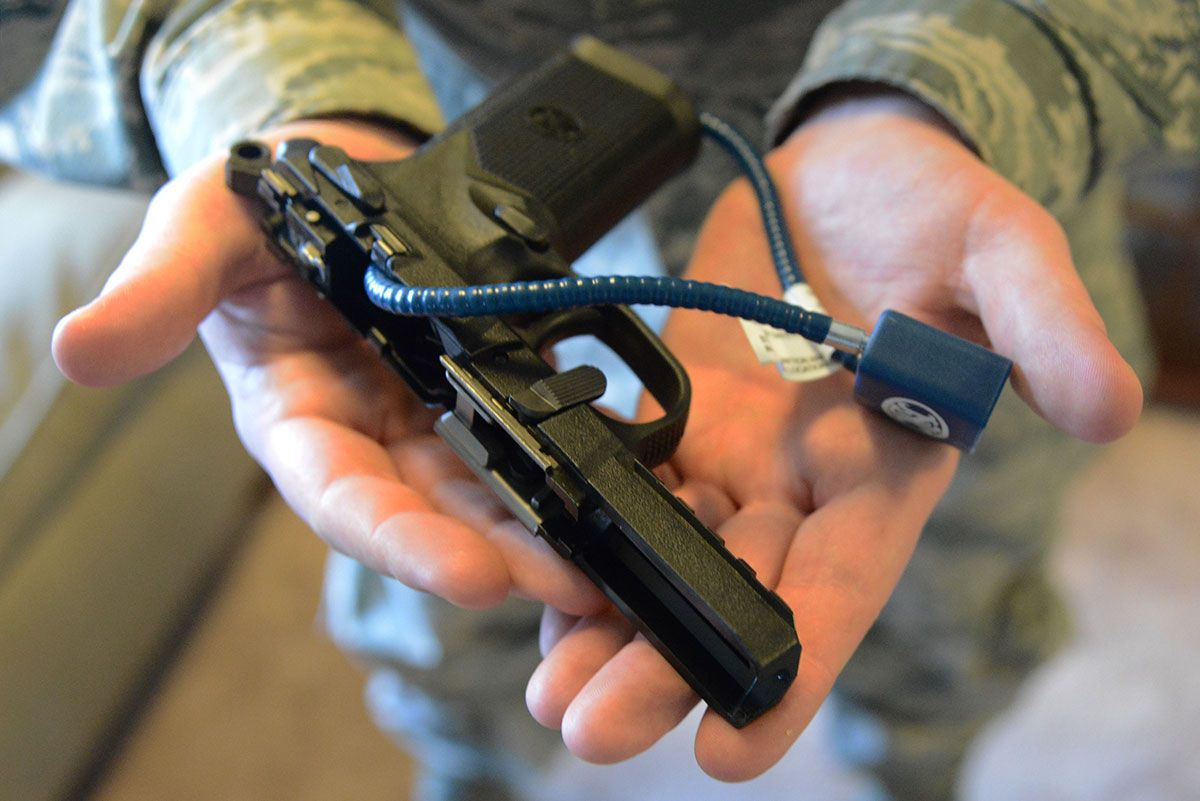 A handgun can be disarmed with a cable lock through its receiver, an acceptable form of “secure storage.” In this case, the gun is also partially disassembled.