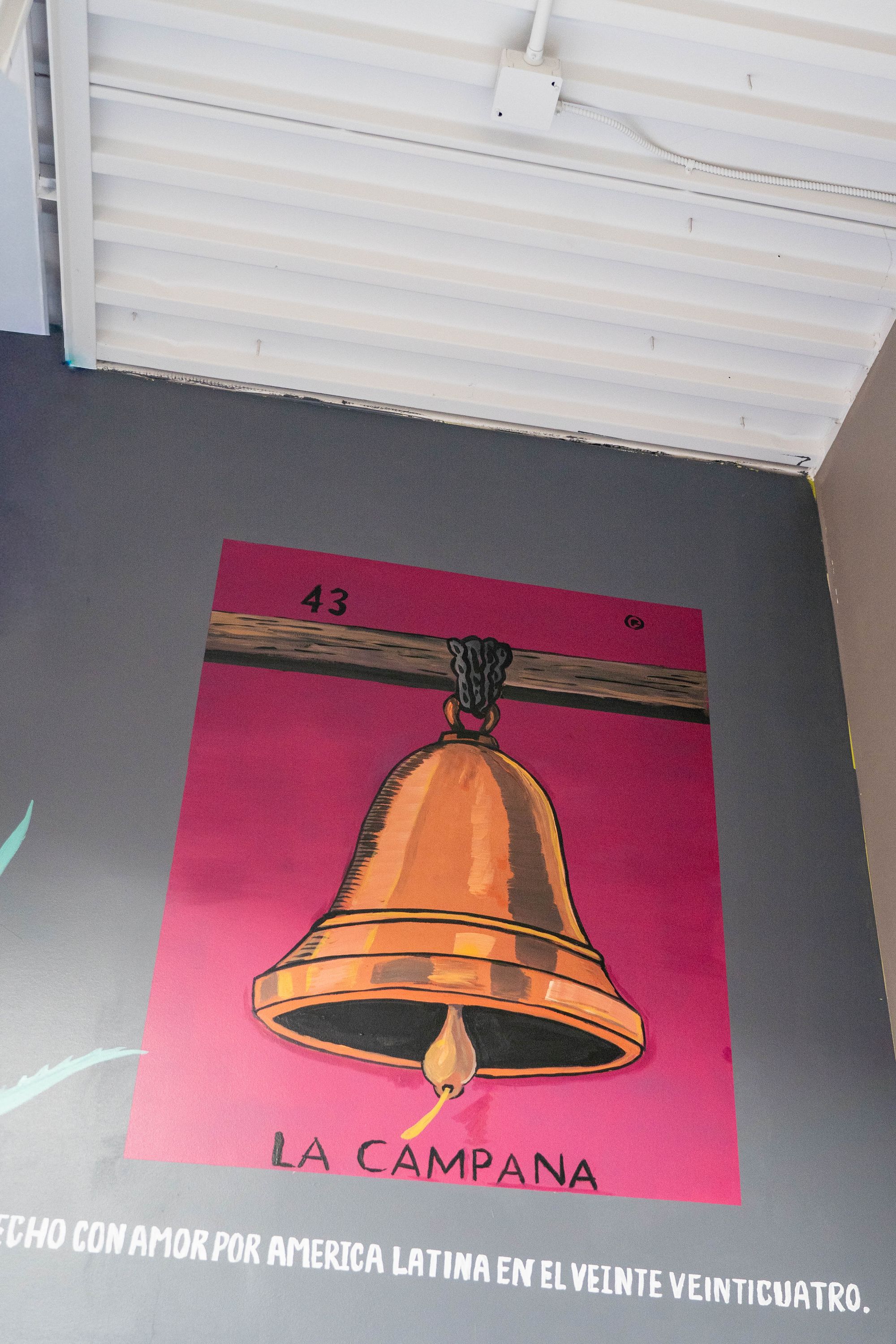 A bell painted on a pink background 