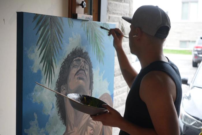 Manuel Murillo painting in his studio in Orleans