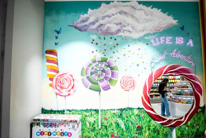 Candy and lollipops on a mall interior store painted with a cotton candy cloud 