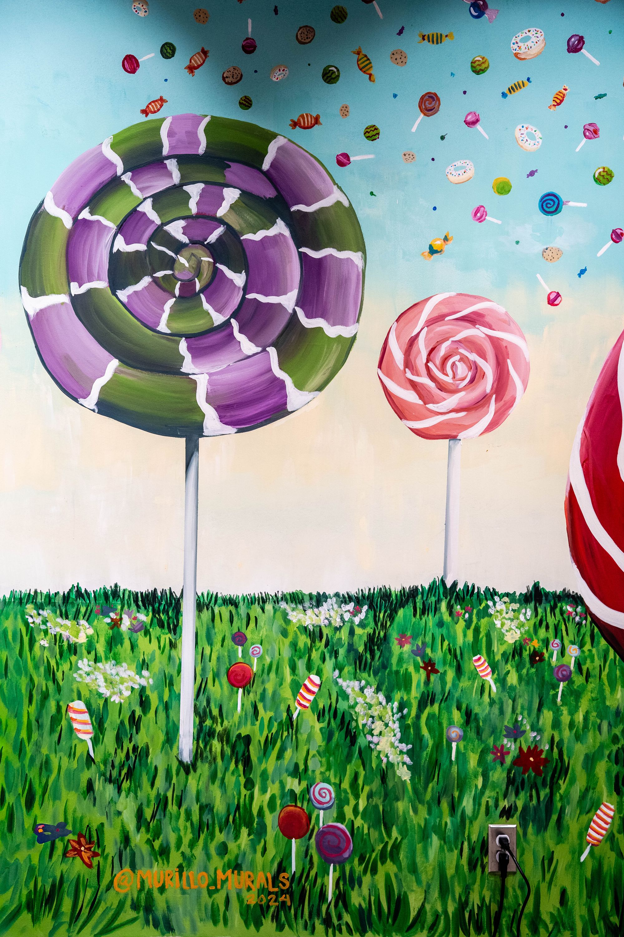 Lollipops painted on a white wall in a candy store