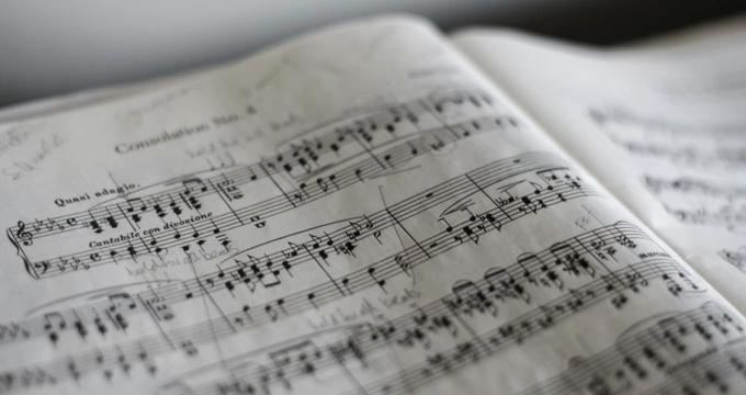 Headphones on the music theory sheets.
