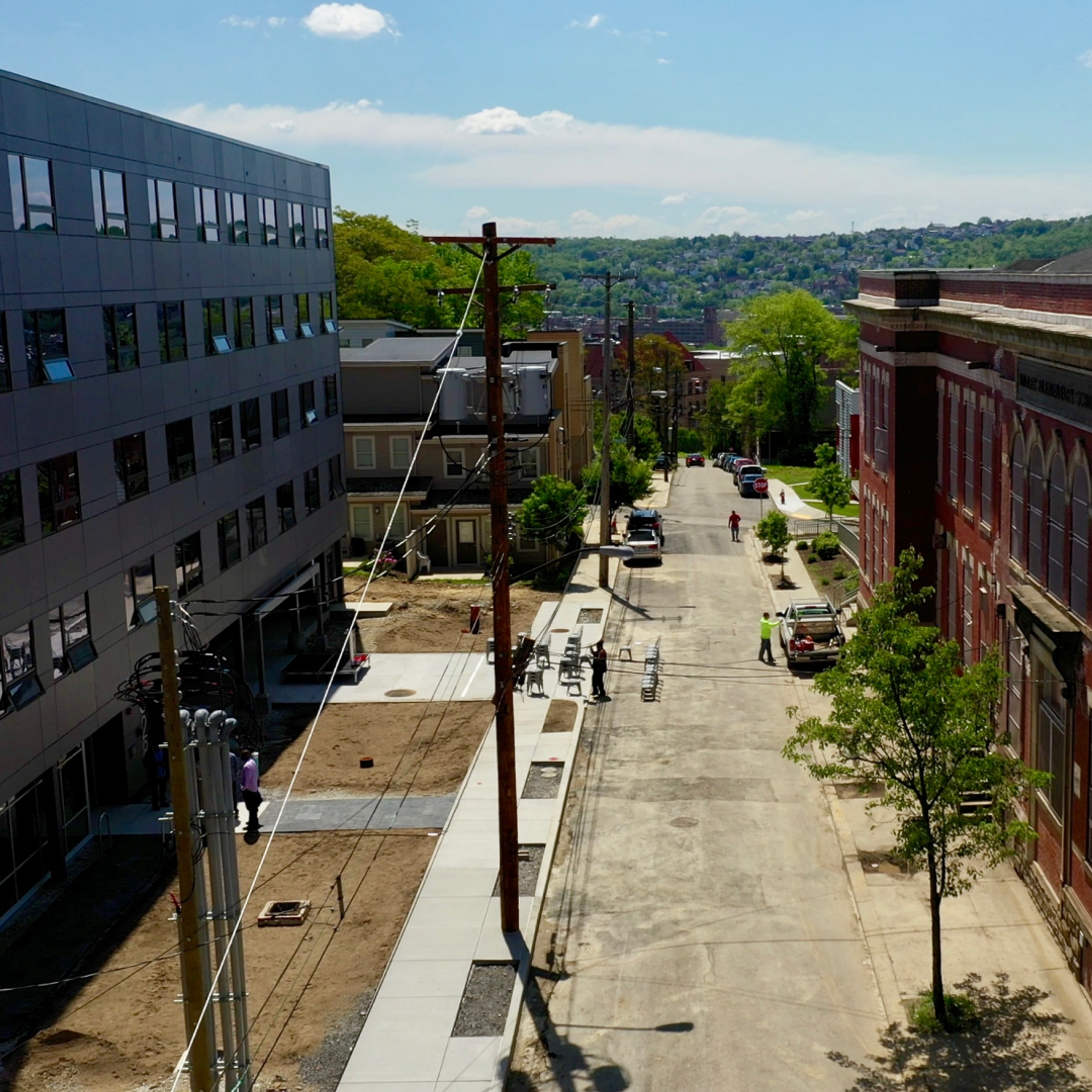 The completed Miller Street Apartments (left) are located right across the street from BTG's upcoming Miller School project (right)