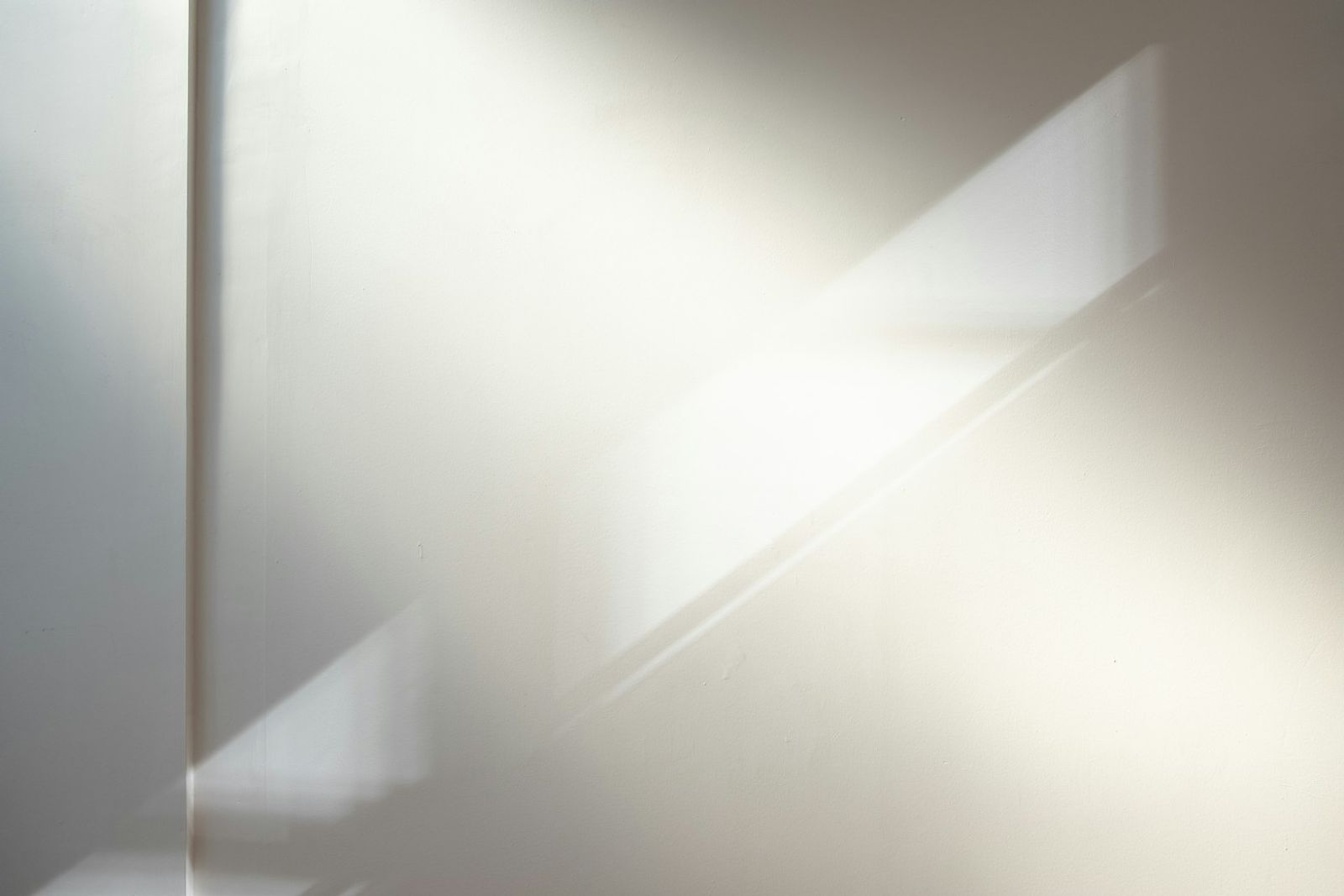Daylight falling across a plain white interior wall