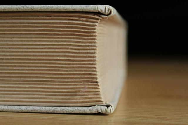 An open English dictionary lying flat, with columns of printed definitions.