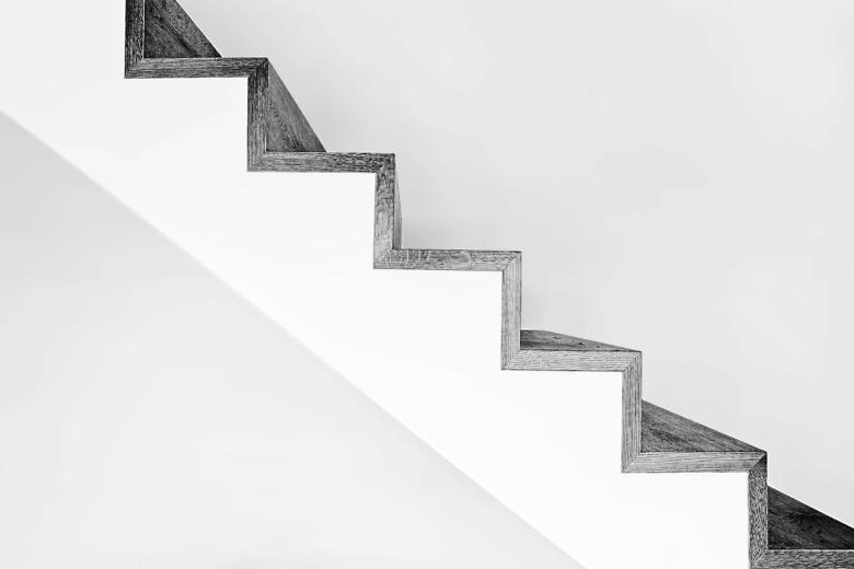 White concrete stairs with black metal railings