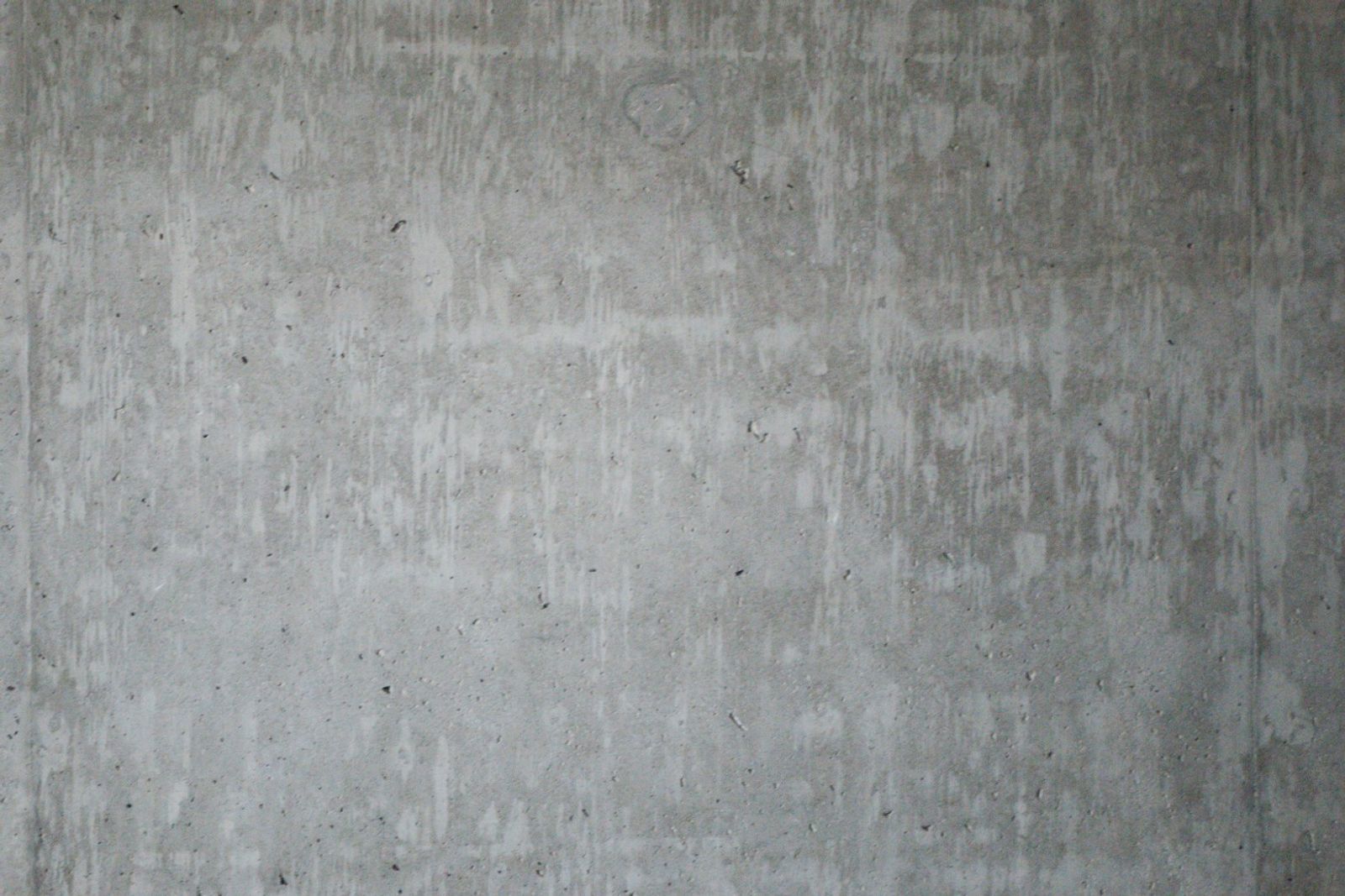 A plain gray concrete wall in flat daylight