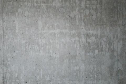A plain gray concrete wall in flat daylight