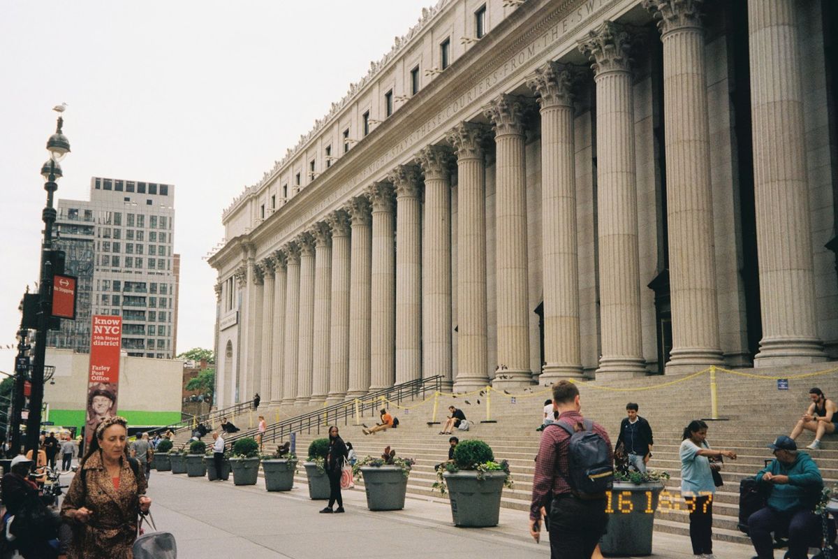 People on the steps of a columned civic building
