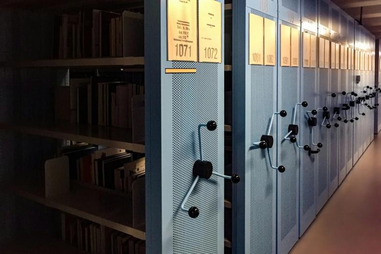 Rows of archive shelving filled with bound records