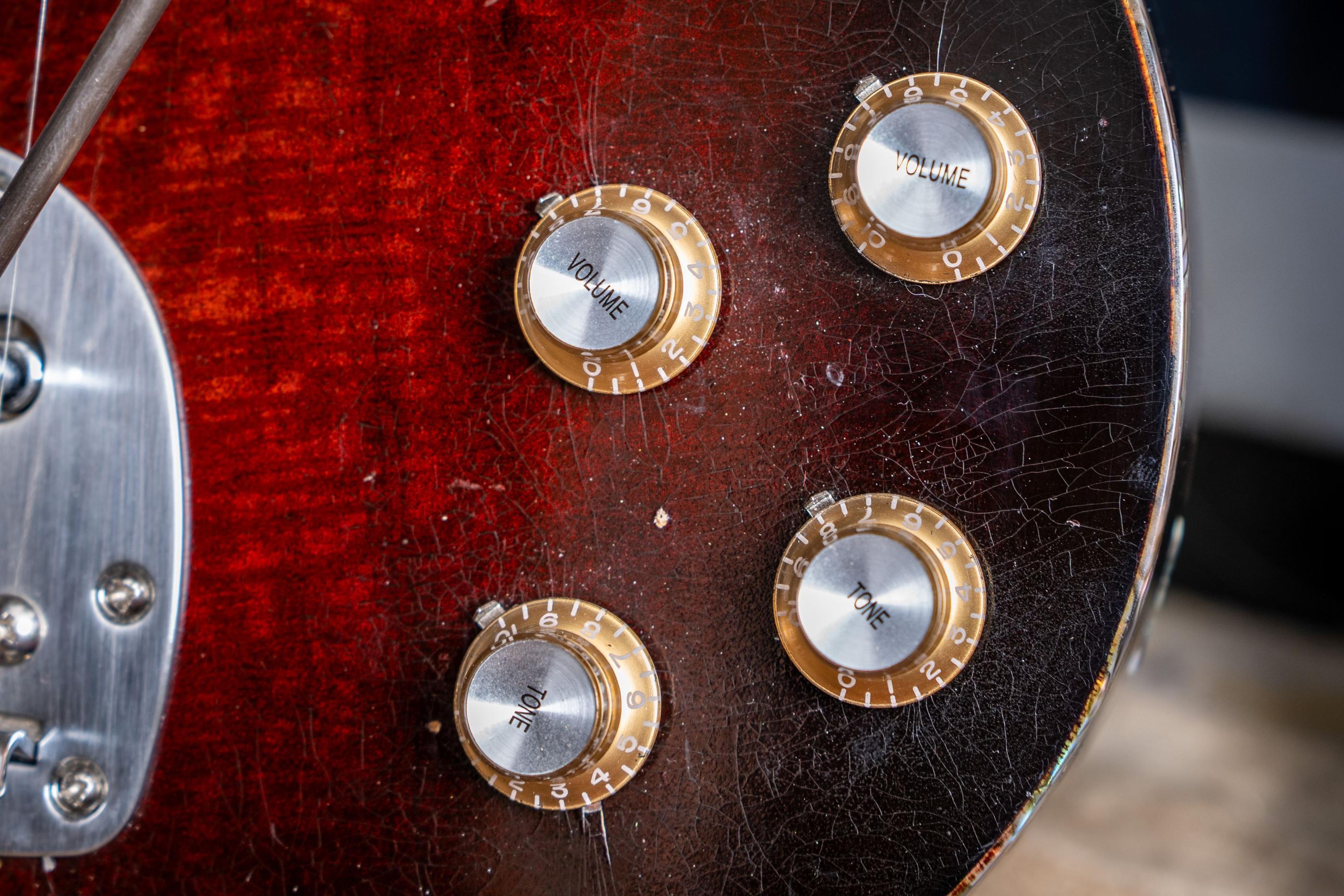 The crazing in the DeVille's wine burst, round the knobs