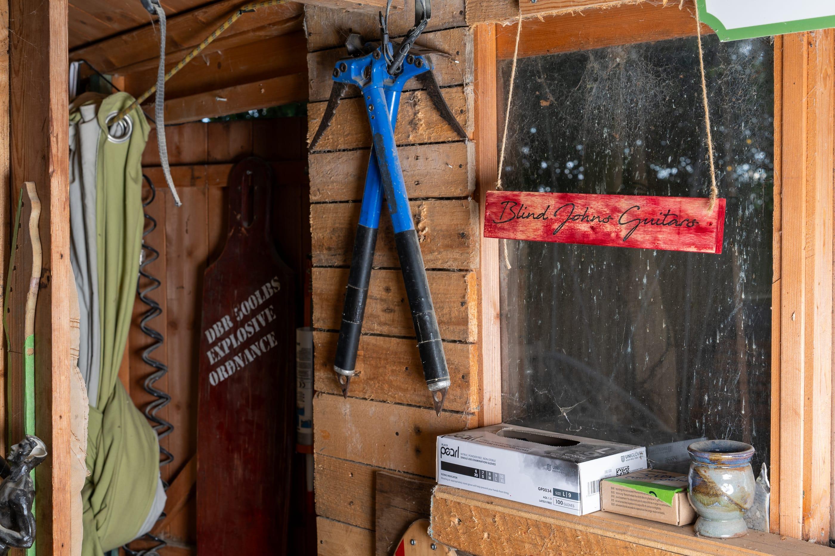 The shed window with the Blind John's Guitars sign in it