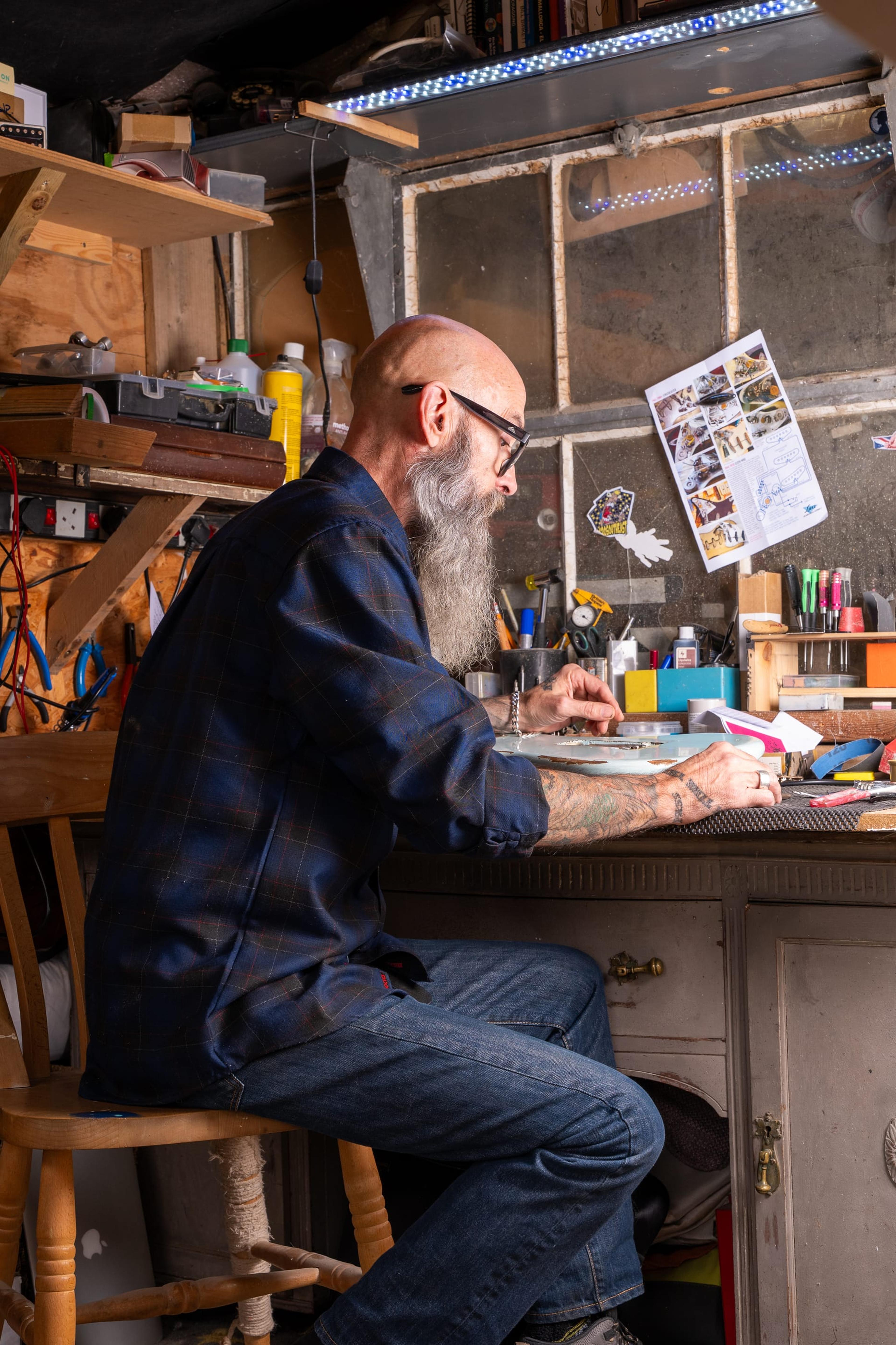John at the bench in the shed, from the side