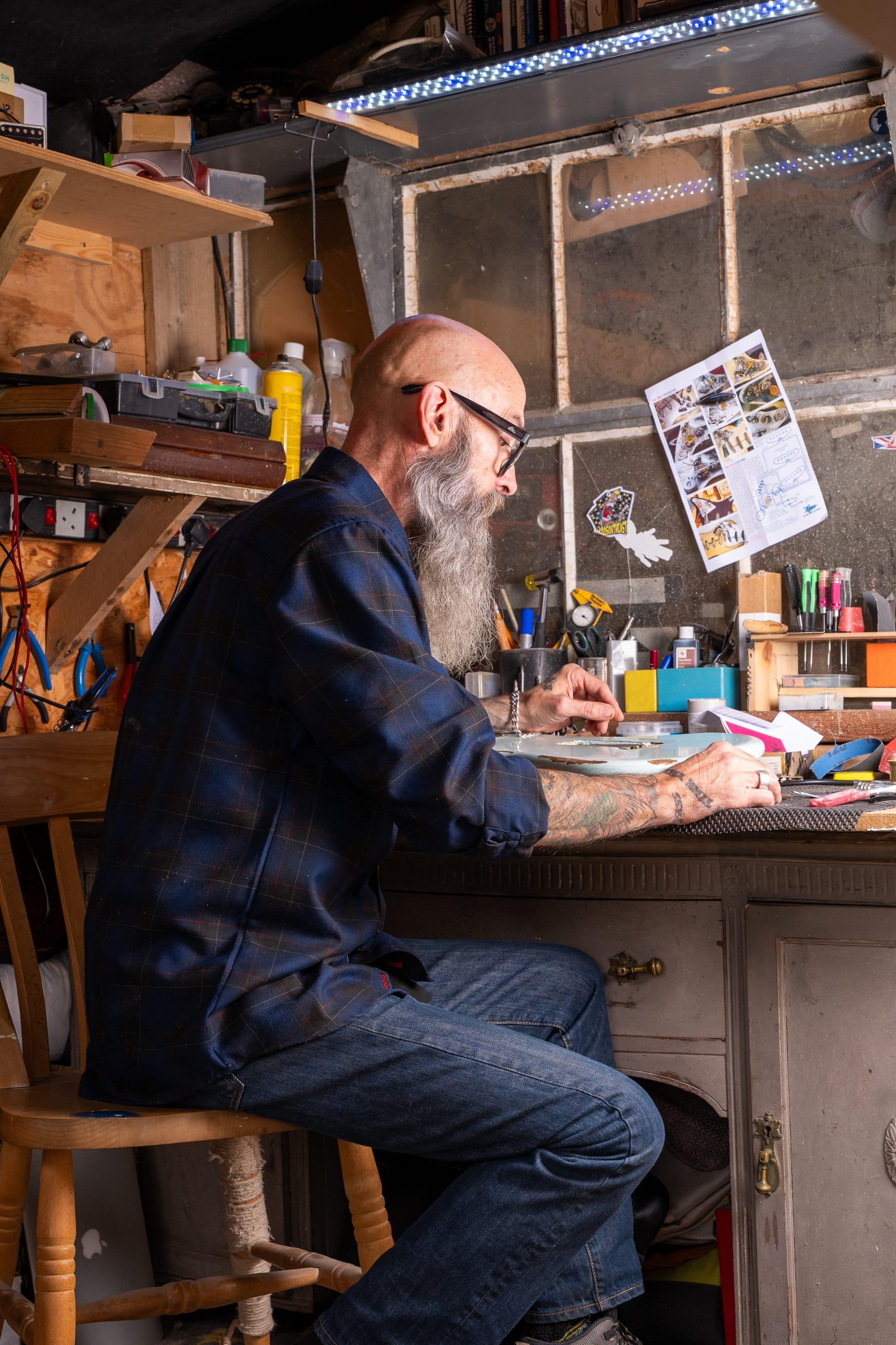 John at the bench in the shed, from the side
