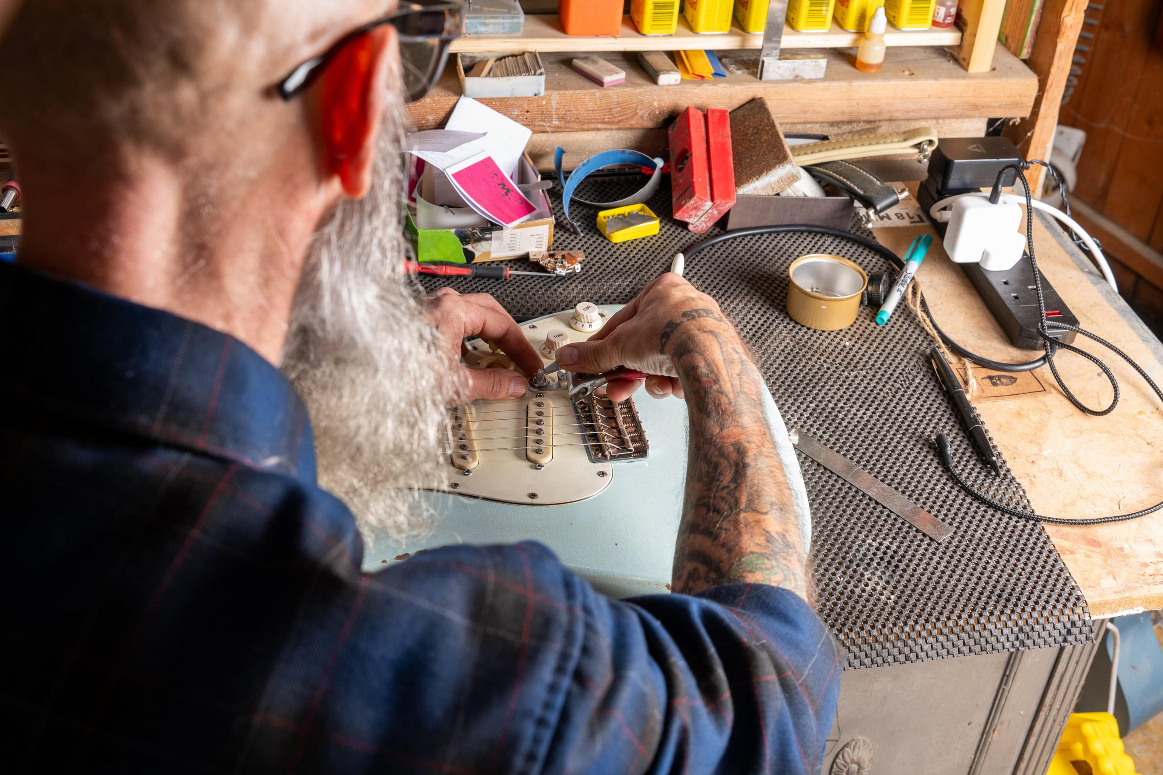 John at his bench, working over Echo's white guard